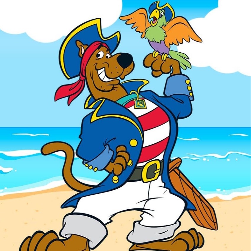 A cartoon dog dressed as a pirate holds a parrot on its hand. The beach scene includes an ocean in the background.