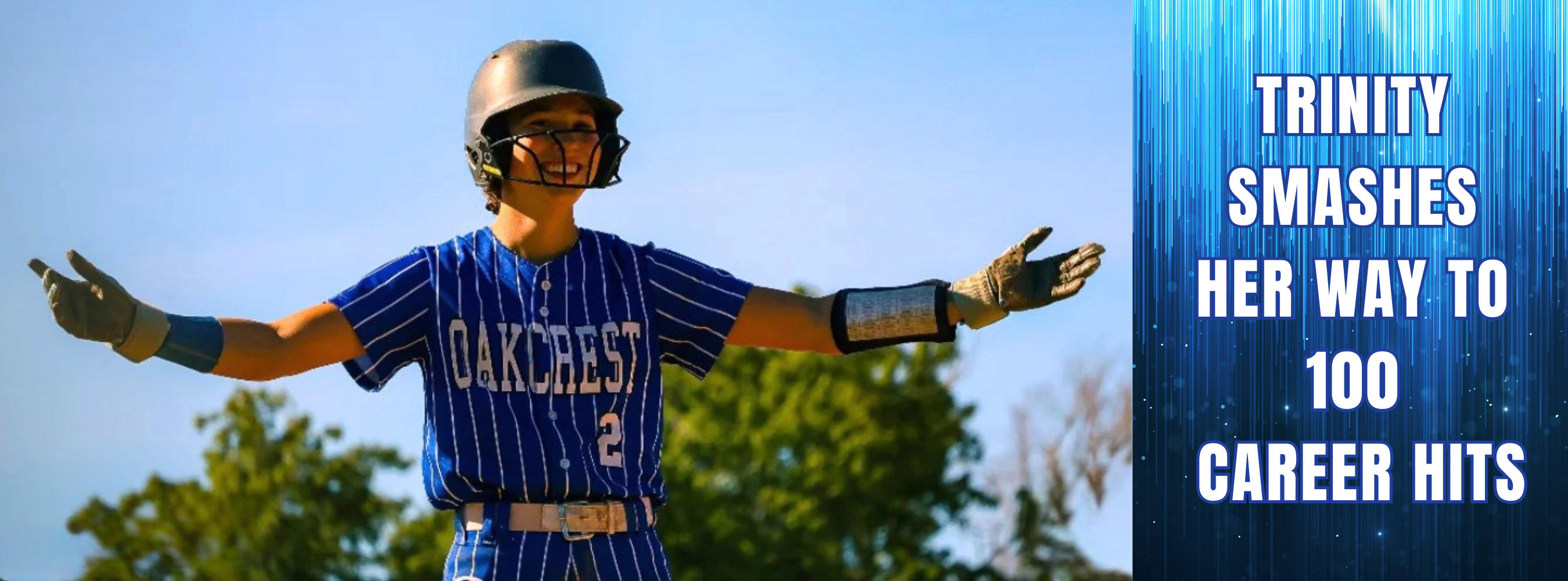 A baseball player in a blue jersey and helmet celebrates with arms raised. Text overlays state "Trinity Smashes Her Way to 100 Career Hits."