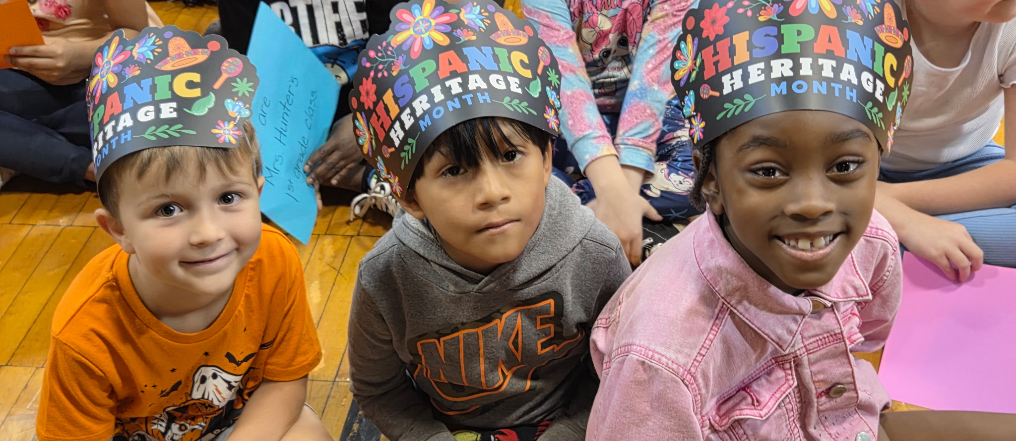 three students with hispanic hats on