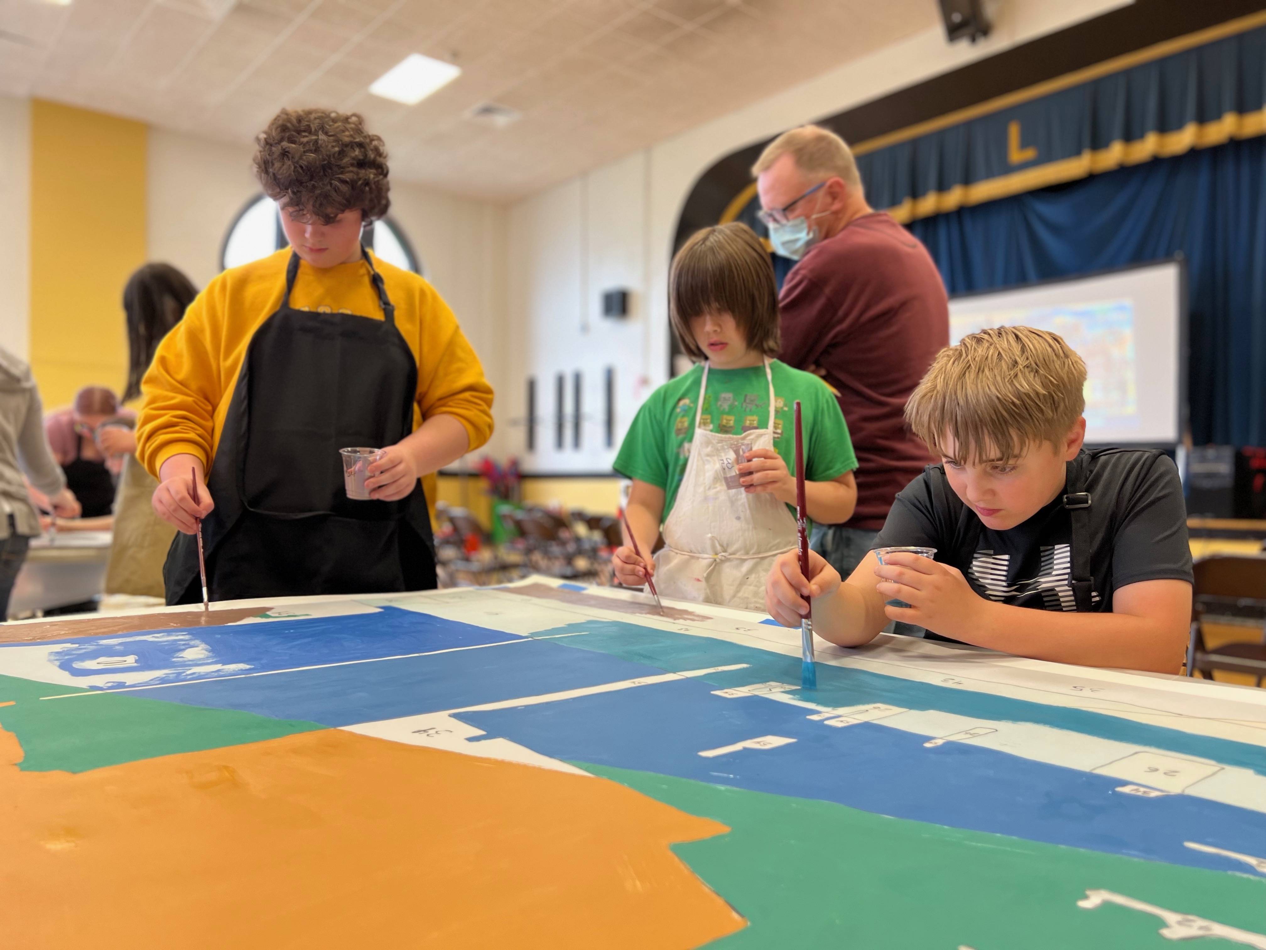 students painting panel