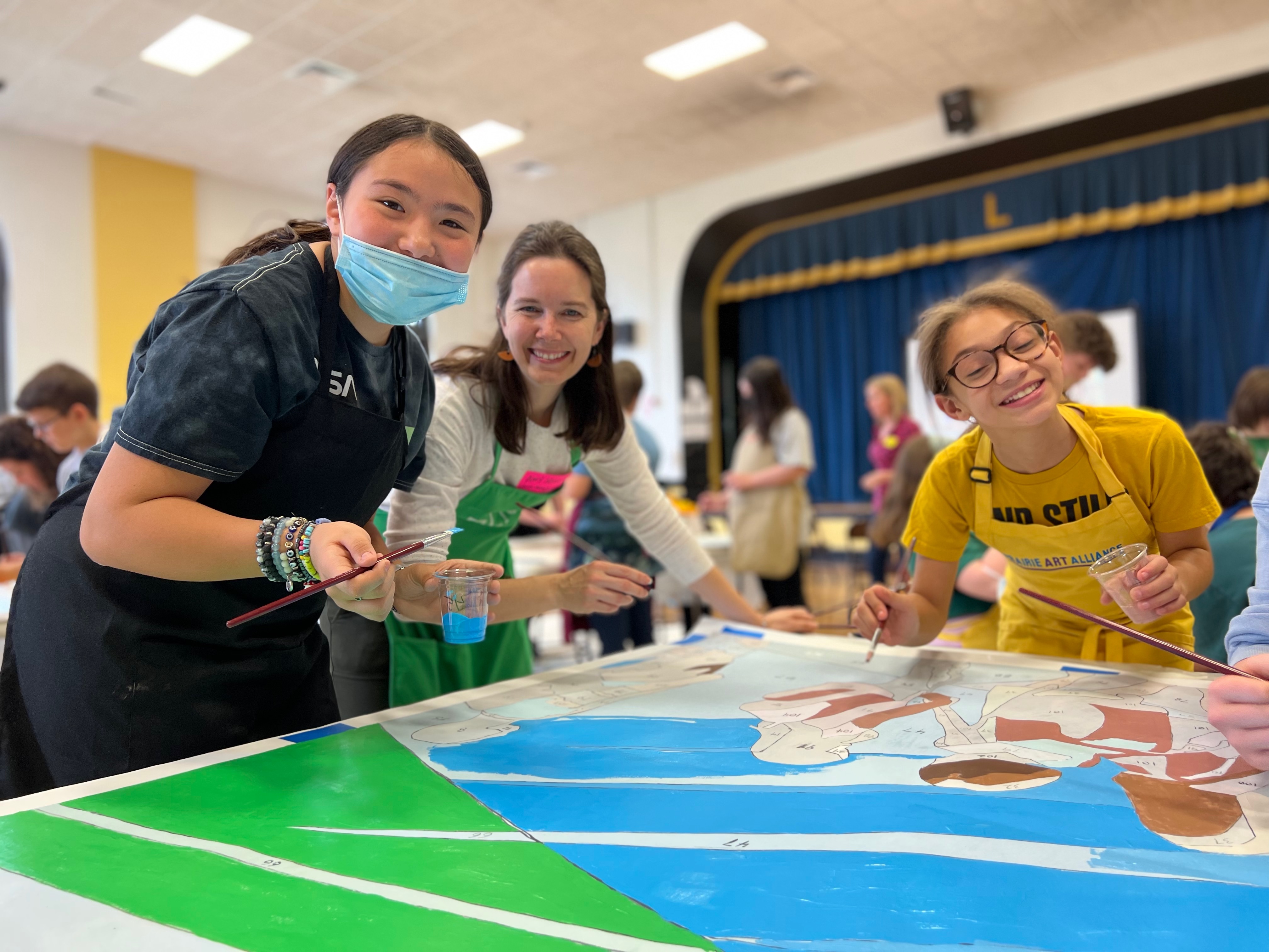 students painting panel