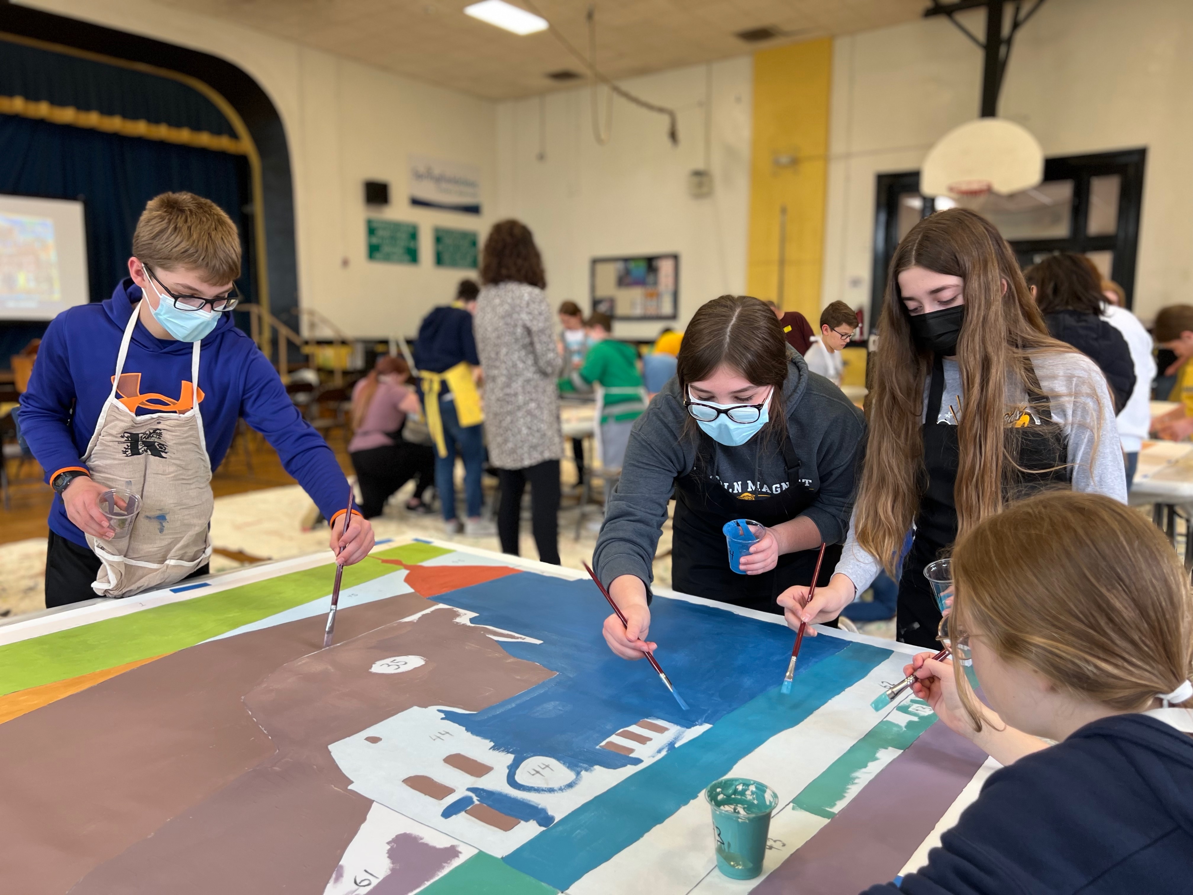 students painting panel