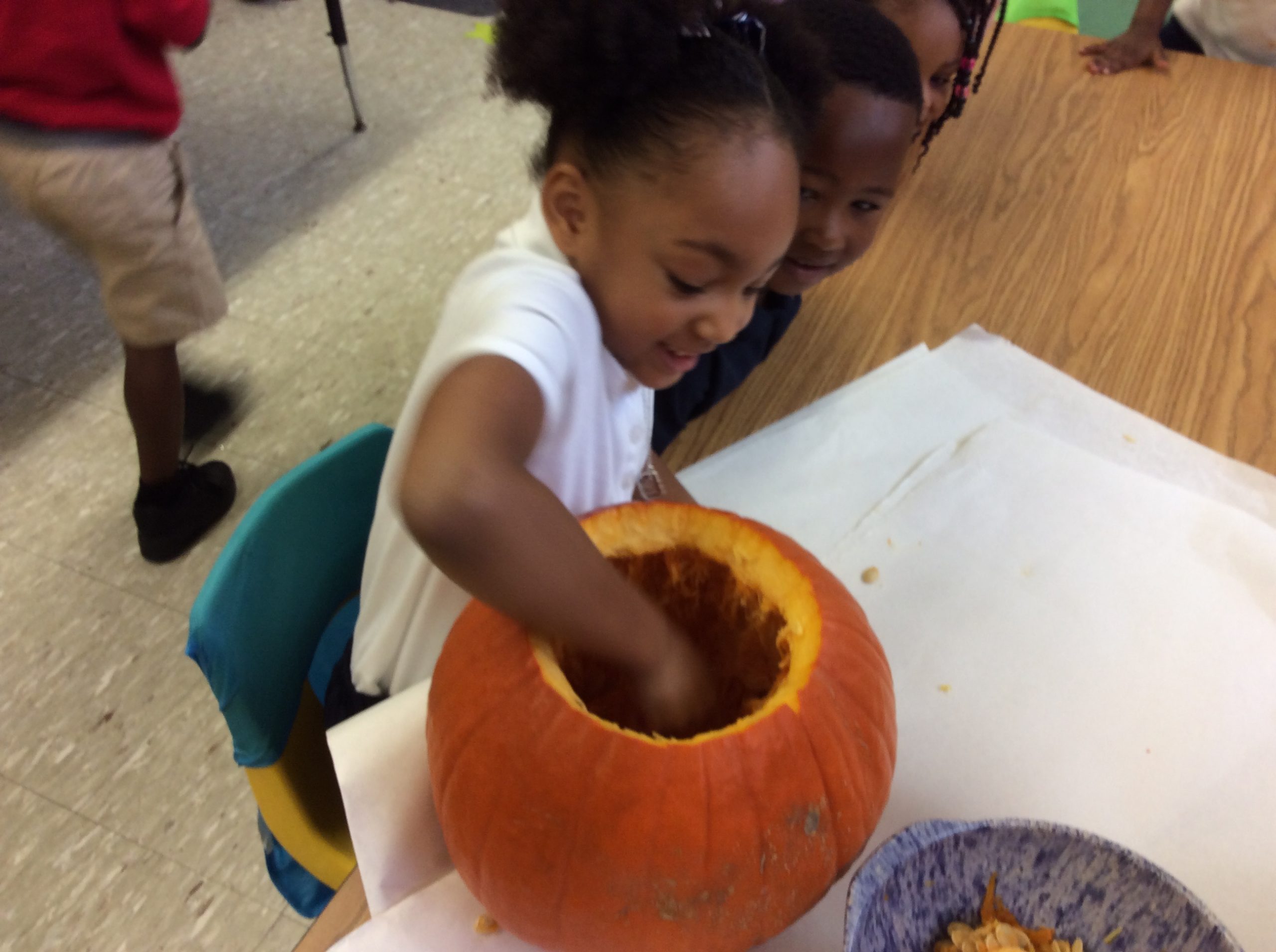 Kid at school with a pumpkin