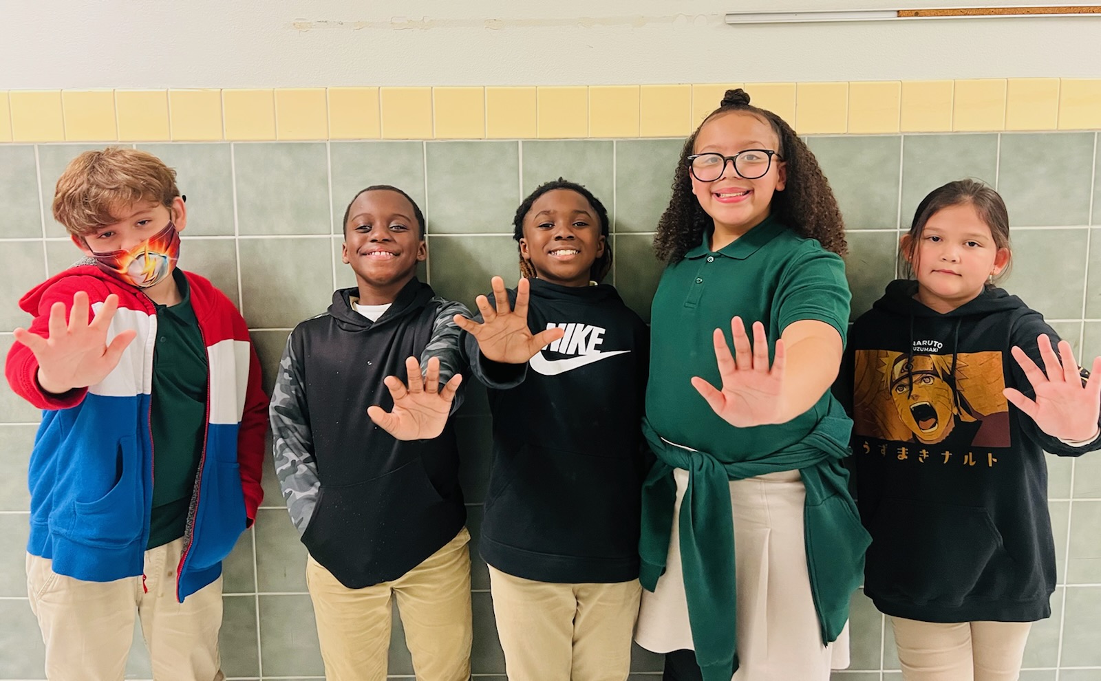 5 Students giving the High 5 sign