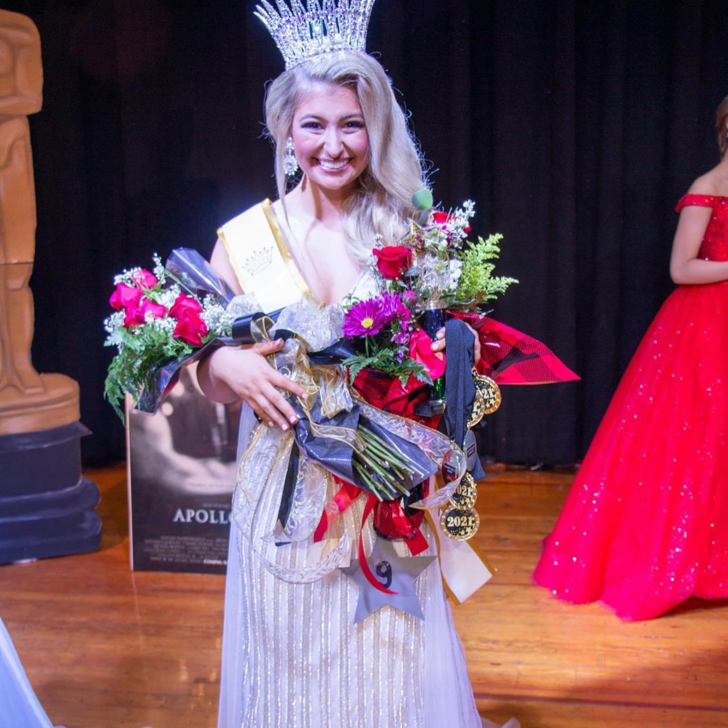 Homecoming queen with flowers and a crown