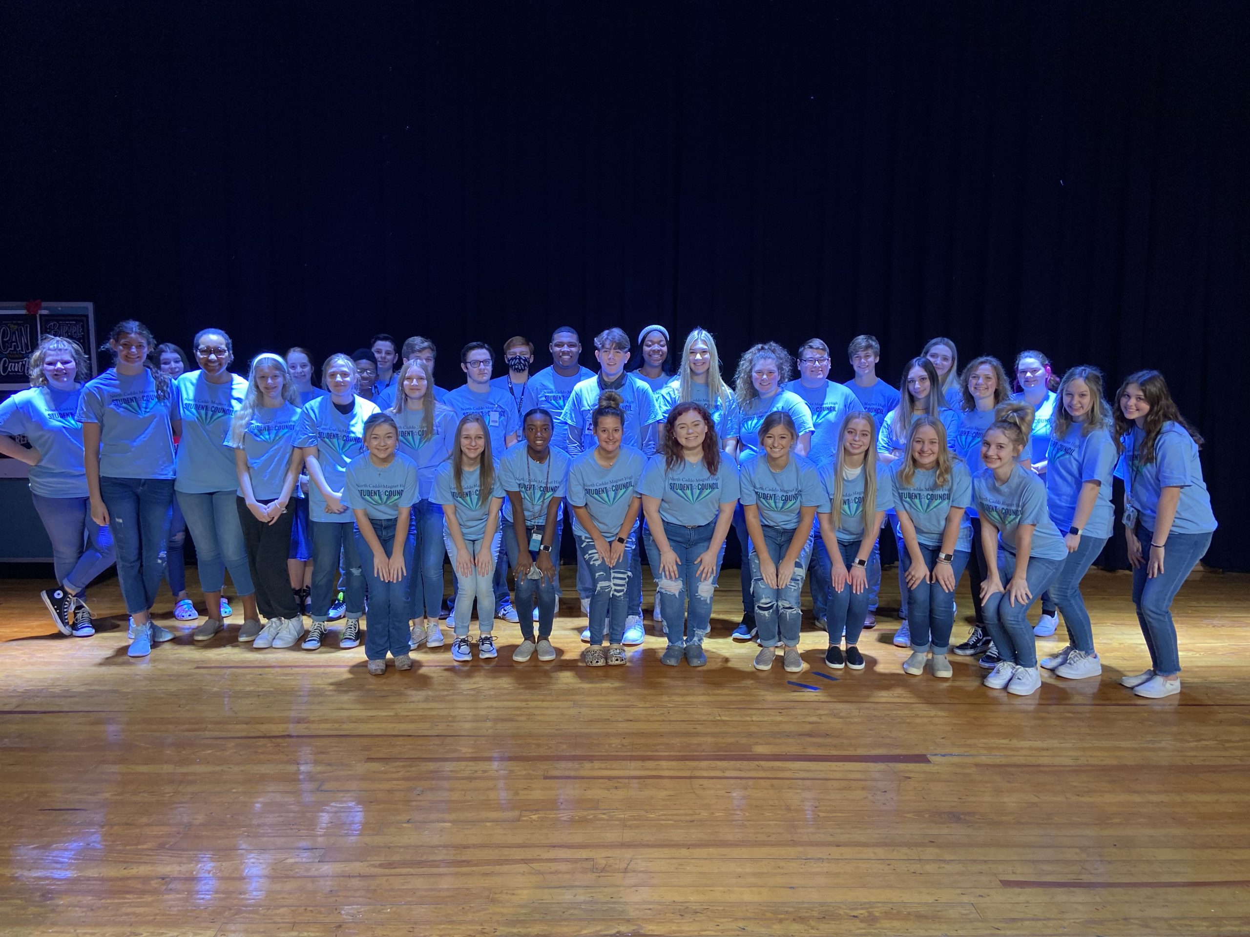 A large group of students posing for a picture on the stage