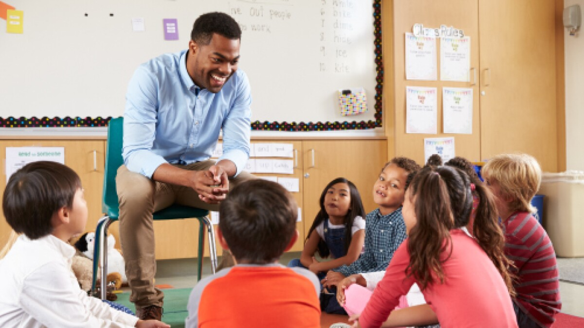 Image of teacher talking with his students