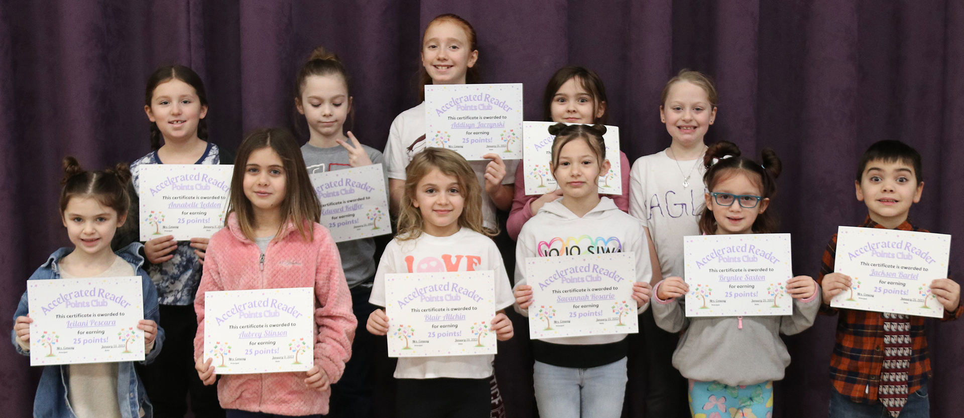 accelerated reader students pose with their certificates