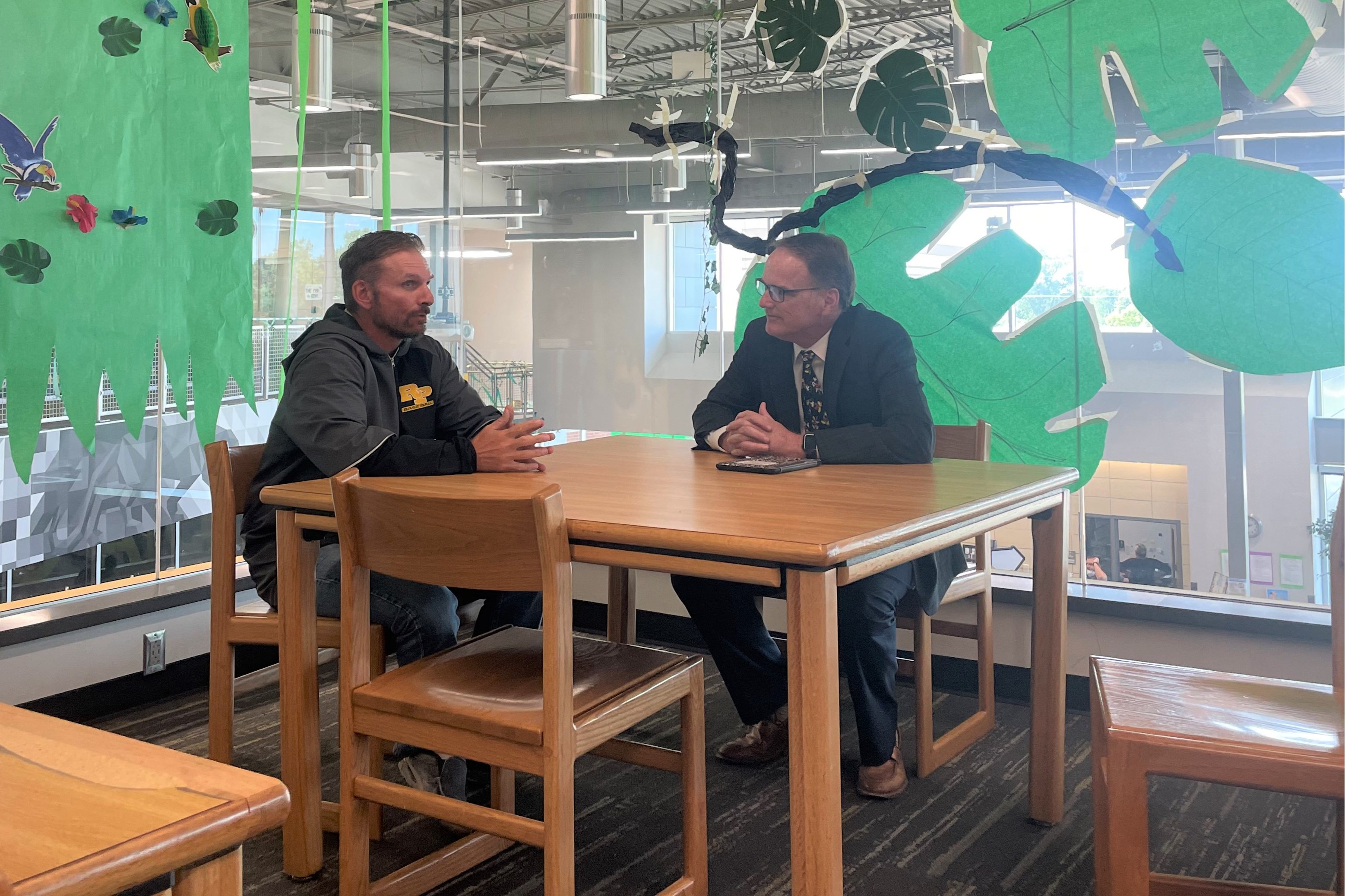 Dr. Mike Slagle talks with RPHS American History Teacher Brandon Ransom.