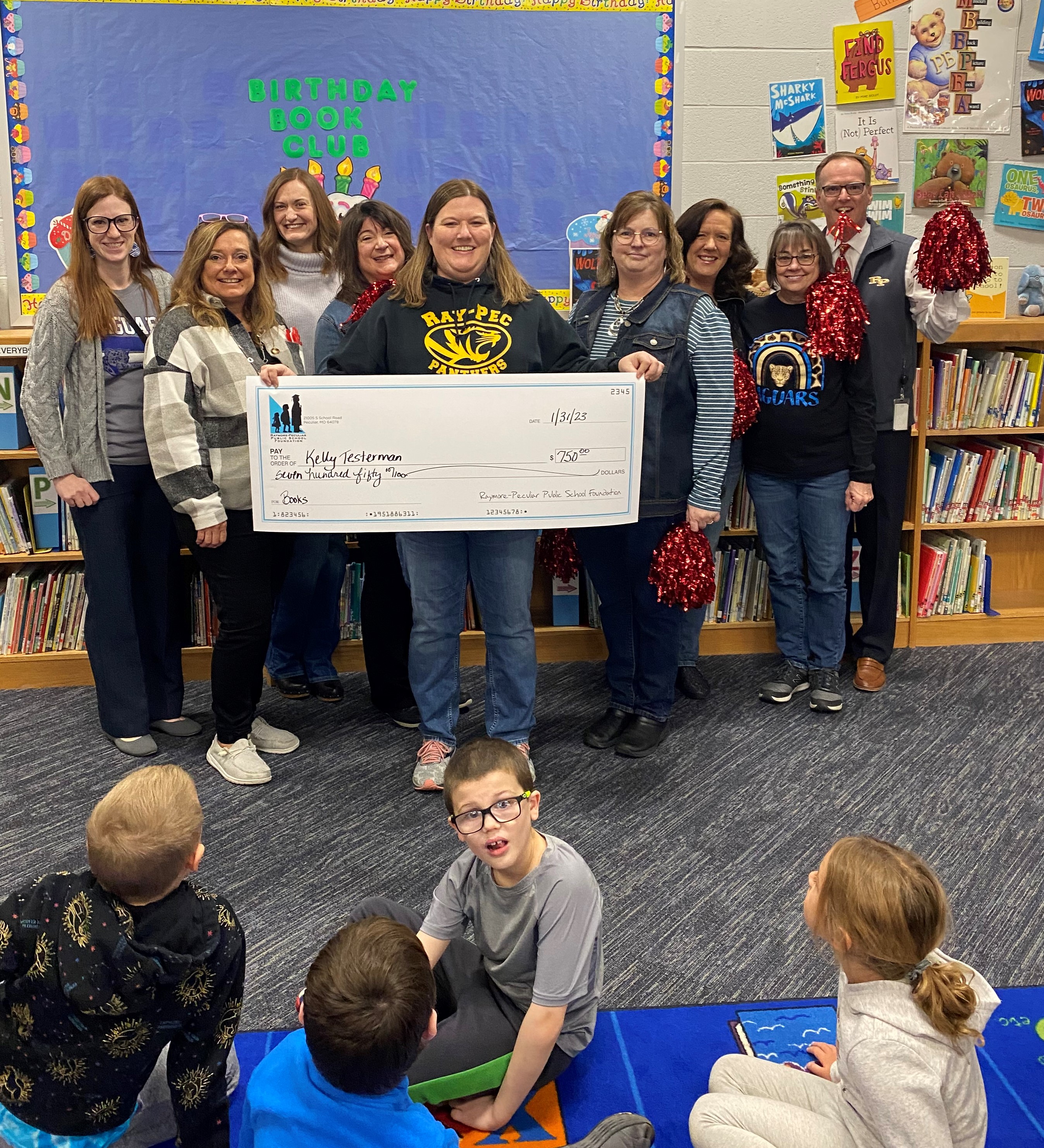 Timber Creek Librarian Kelly Testerman holds a giant check