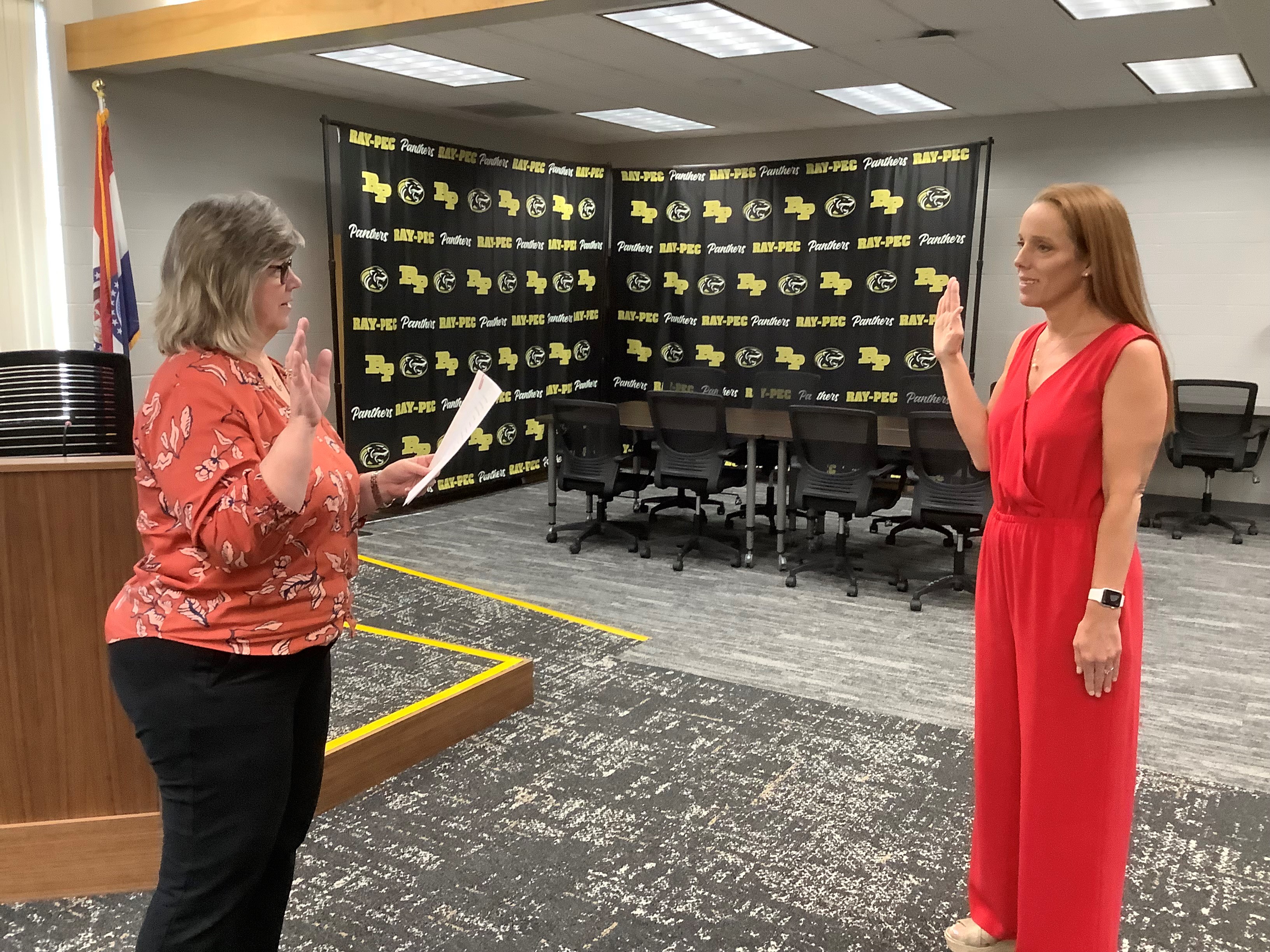 Pam Steele administers the oath of office to new Board Member Patty Phillips