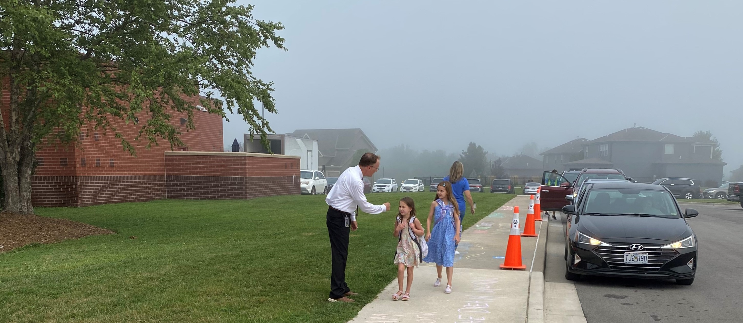Dr. Mike Slagle greets students on the first of school.
