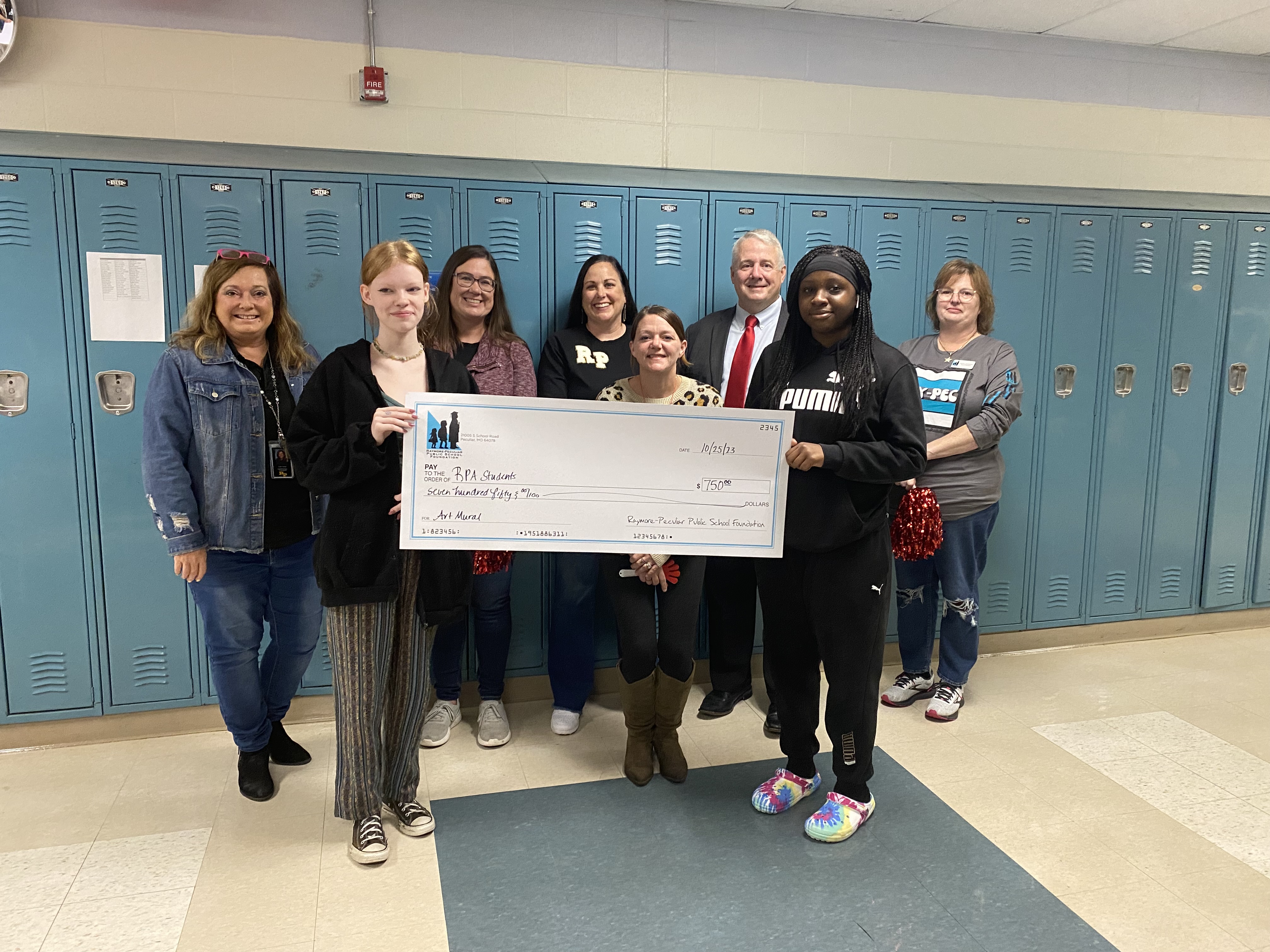 RPA students hold giant check