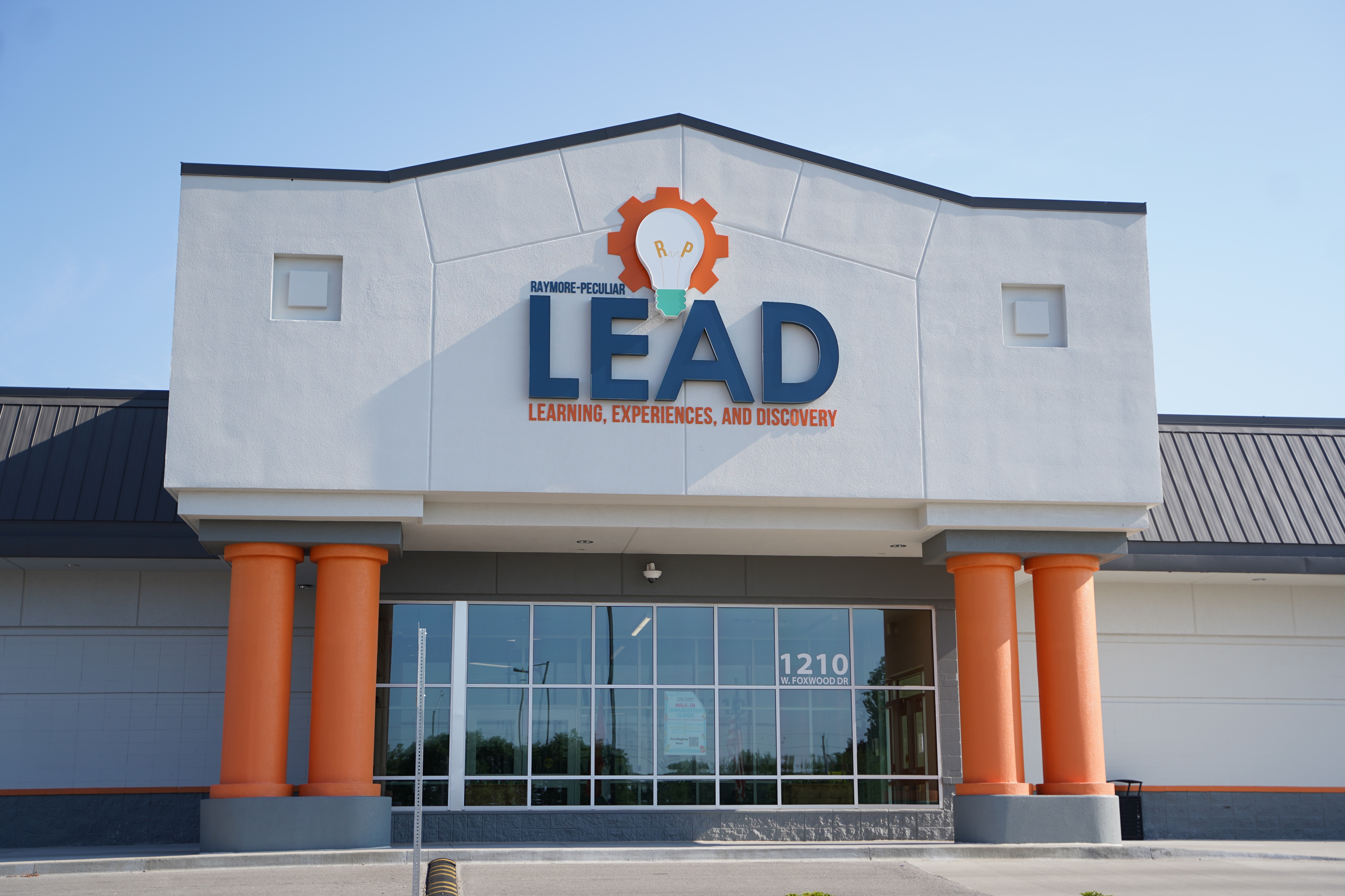 The front of a building that reads, "Raymore-Peculiar LEAD Learning, Experiences, and Discovery."
