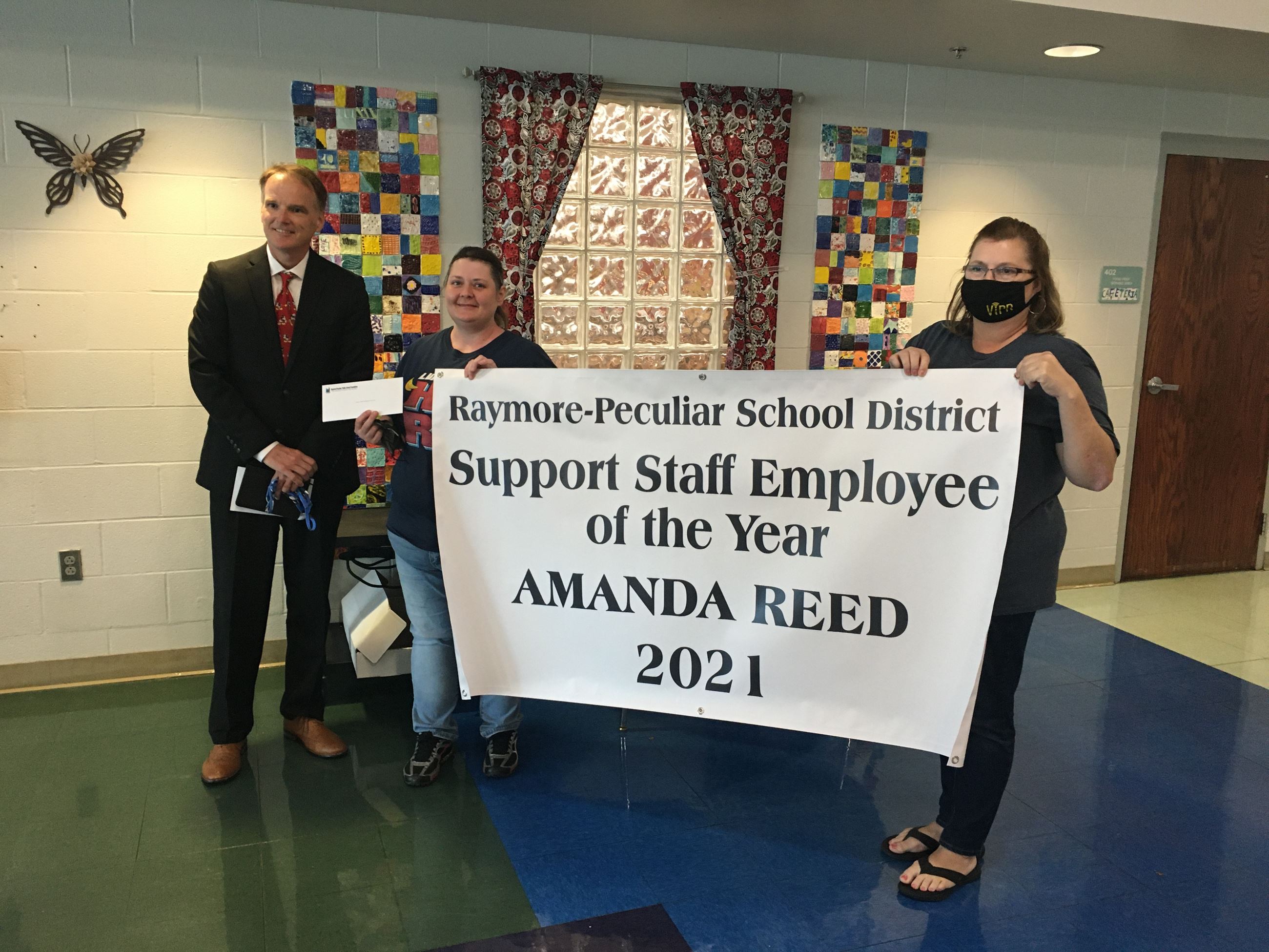 Support Staff Employee of the Year Amanda Reed is pictured with Superintendent Dr. Mike Slagle, at left, and School Board President Ruth Johnson, at right.