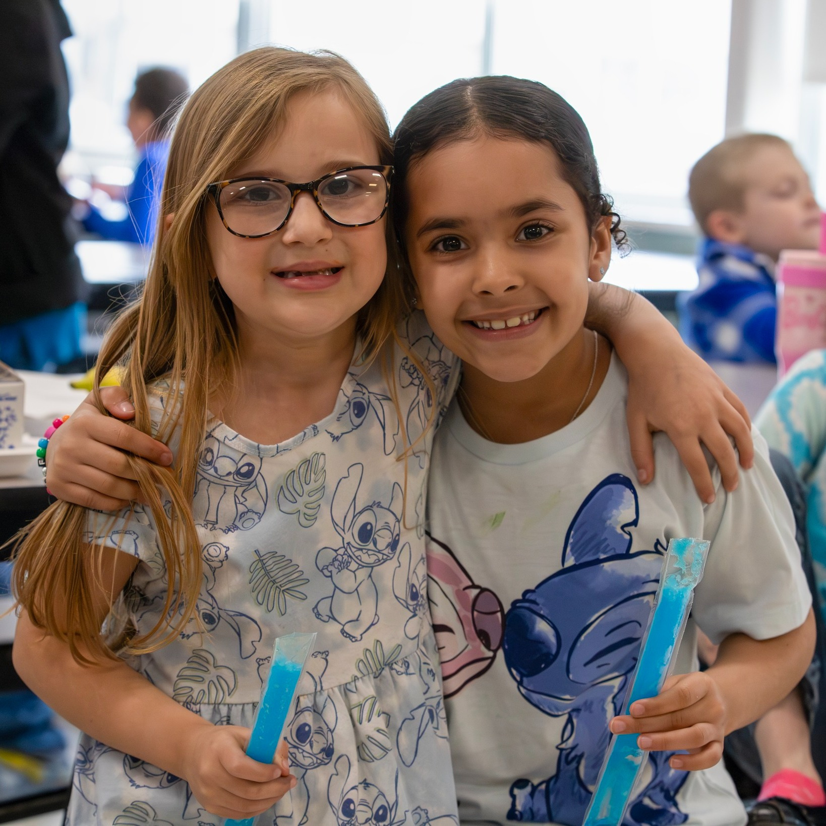 Students smiling and hugging
