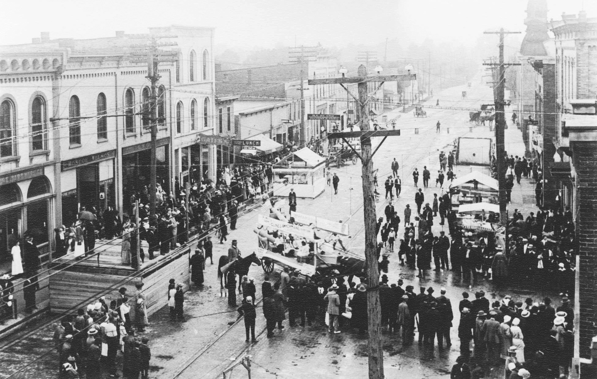 Parade – prior to 1916.  Cline & Awkerman Lumber Company float turning on to North Street from West Main Street.  Hardware store, Roscoe Wilson’s store, G. W. Gust store, Gates Clothing store on south side of W. Main Street.