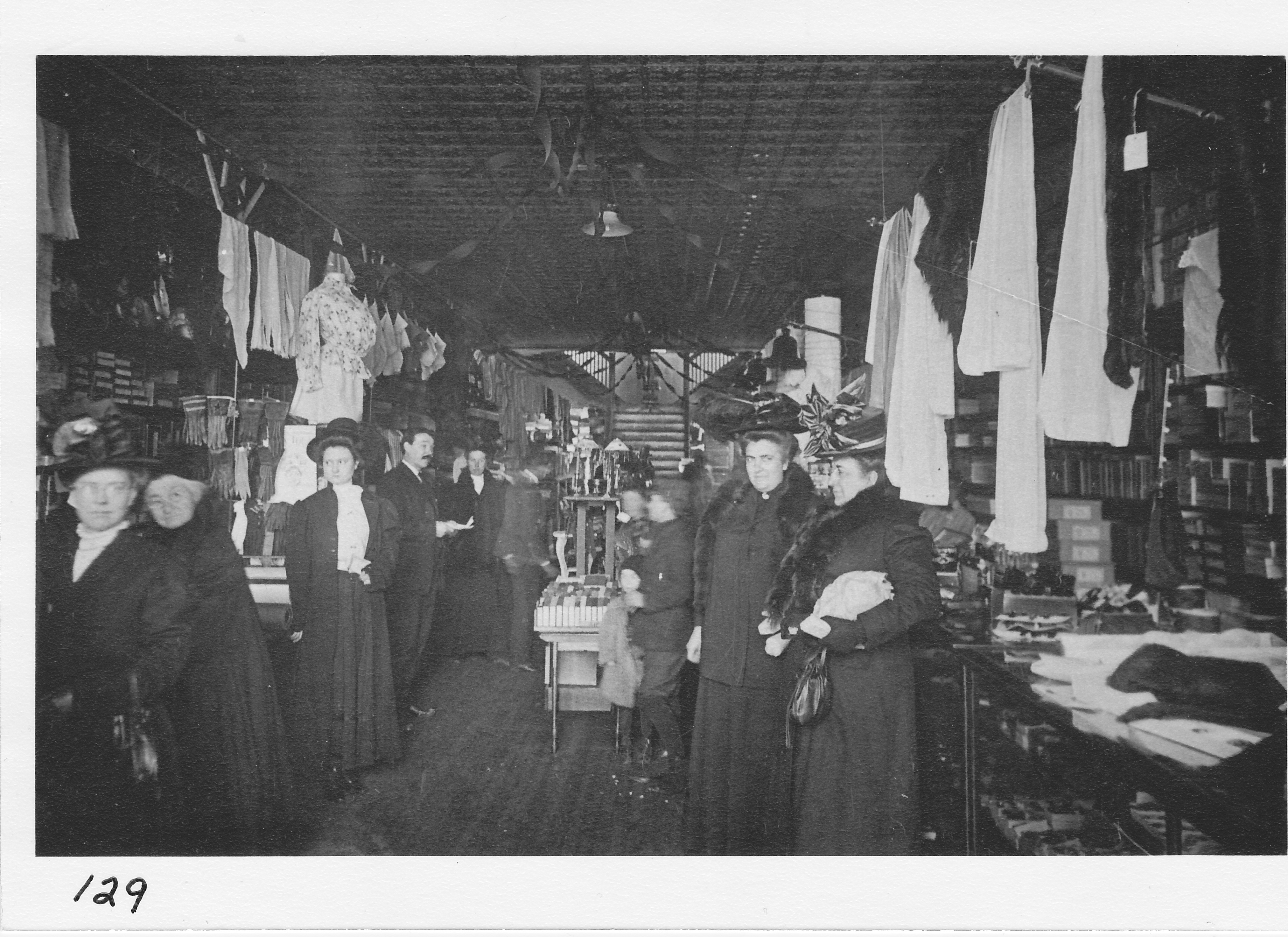 Interior view of the “Fair Store” main floor (Cottrell Bros., West Main St., now Village Inn restaurant.  Standing fourth from left is Clark Cottrell, Sr., owner.