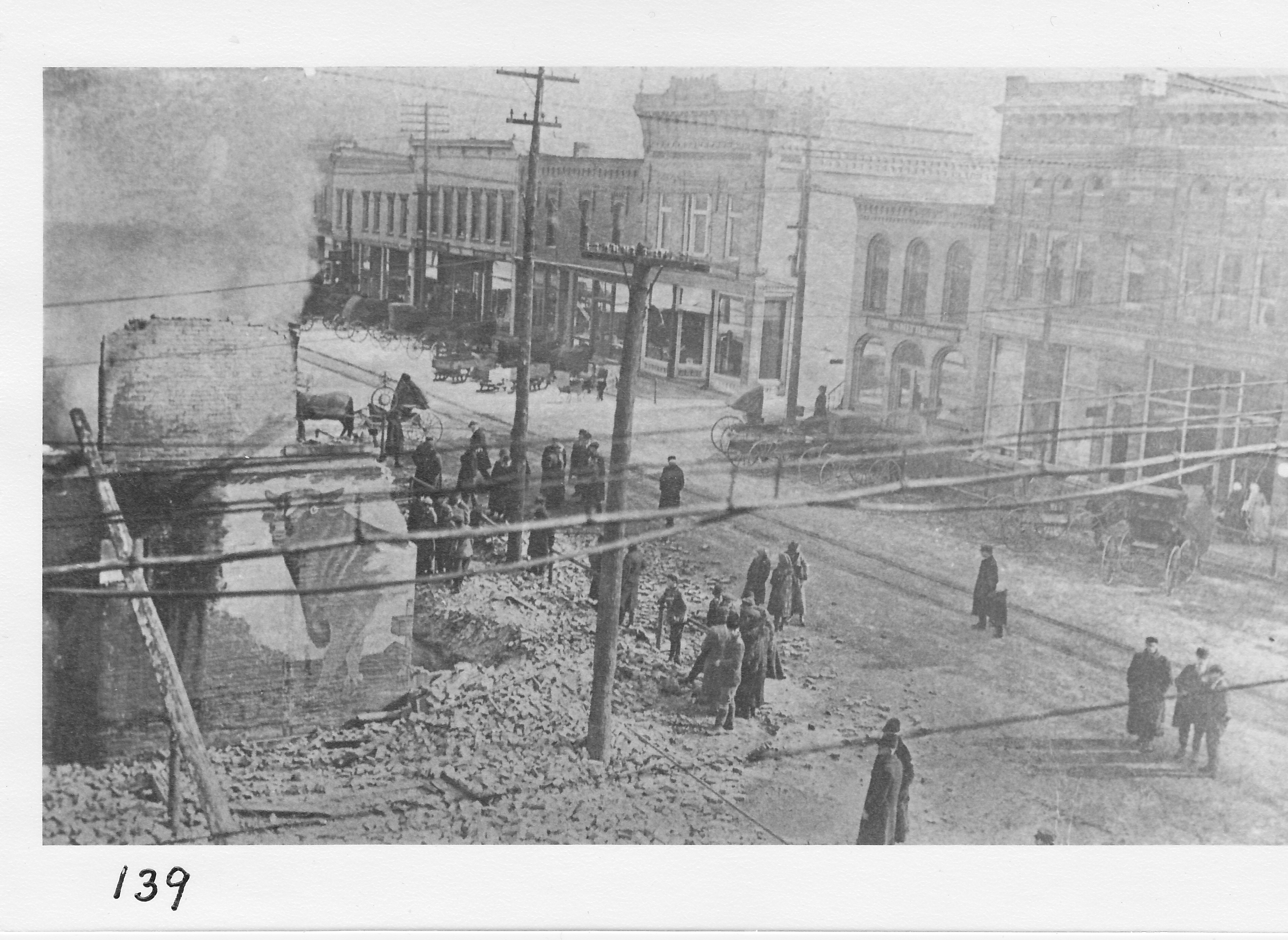Morning after the fire in January 1912, northeast corner of West Main and North Streets.