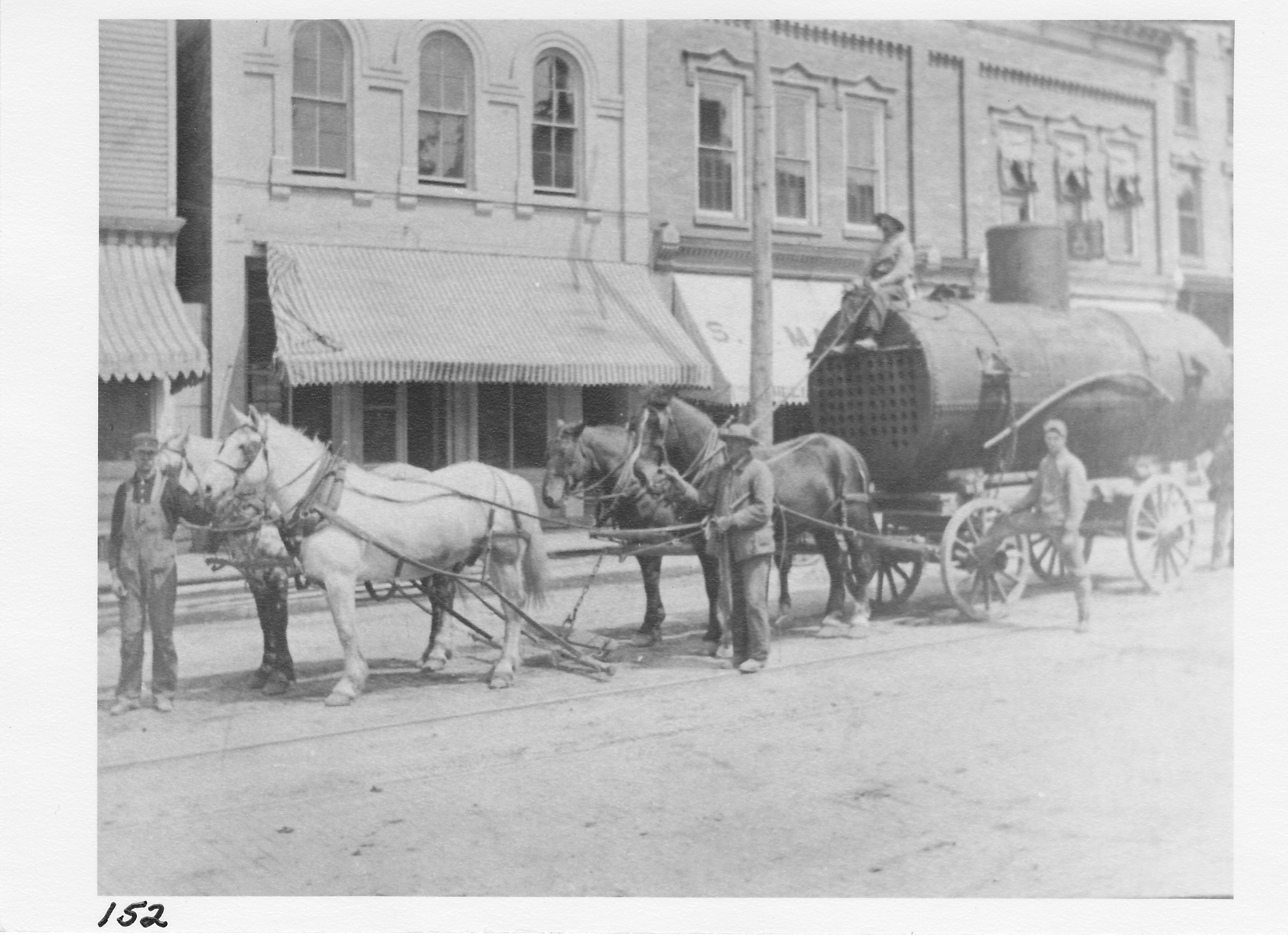 Photo in 1901 of Porter Cartage Service moving steel boiler for new Brick & Tile Co. (Herb Sims and Ed Clark).  Site was in the rear of the M & S building site on Salisbury Street.  (l-r) Elmer Porter, Jonas Henry, Charles Bauman, Olef Heckman, Bert Skates.