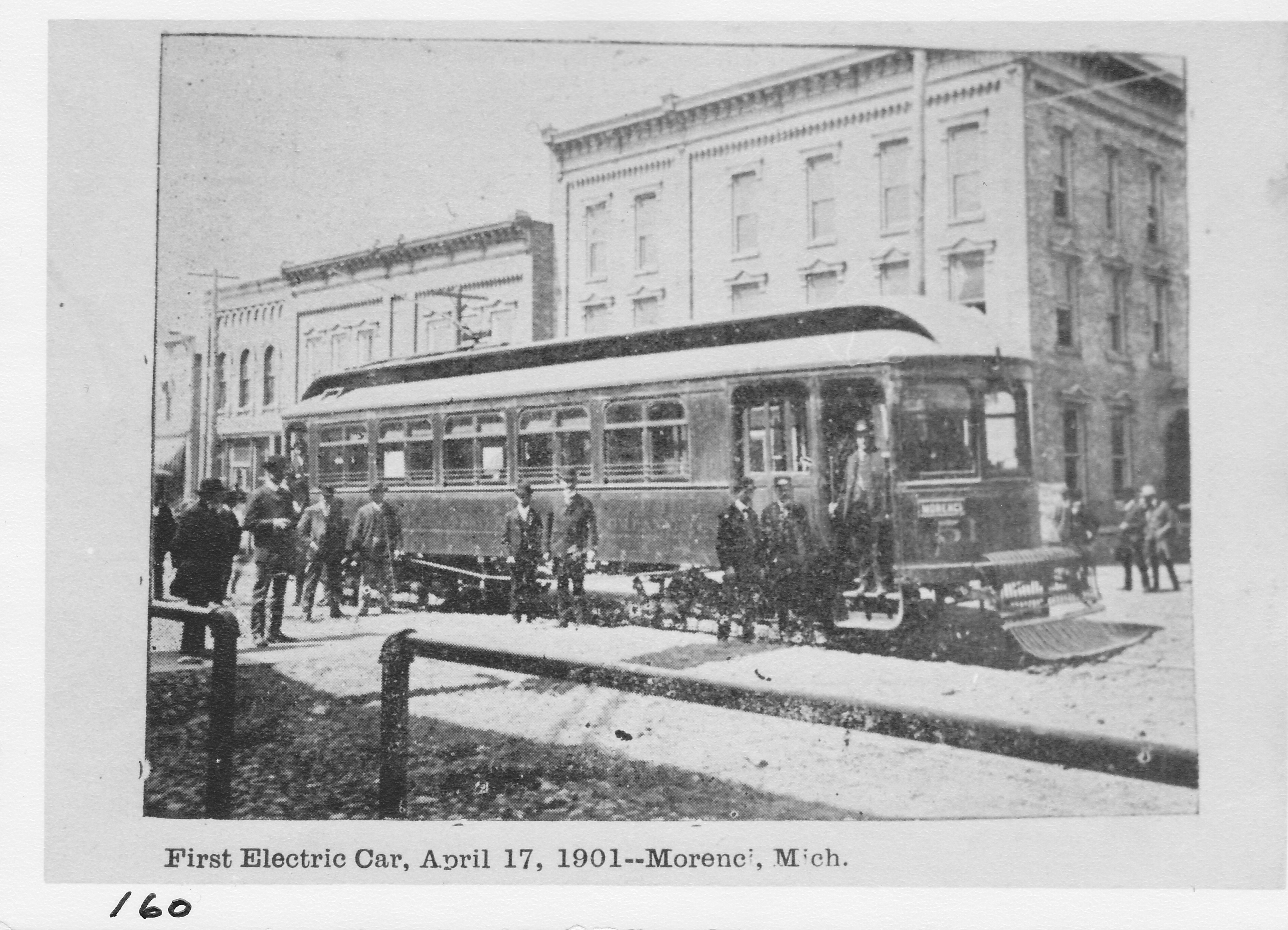 First east-bound Toledo & Western car at hotel corner April 1902.  Date on card photo is in error. The electric train was also known as the Teeter & Wobble, among other names.