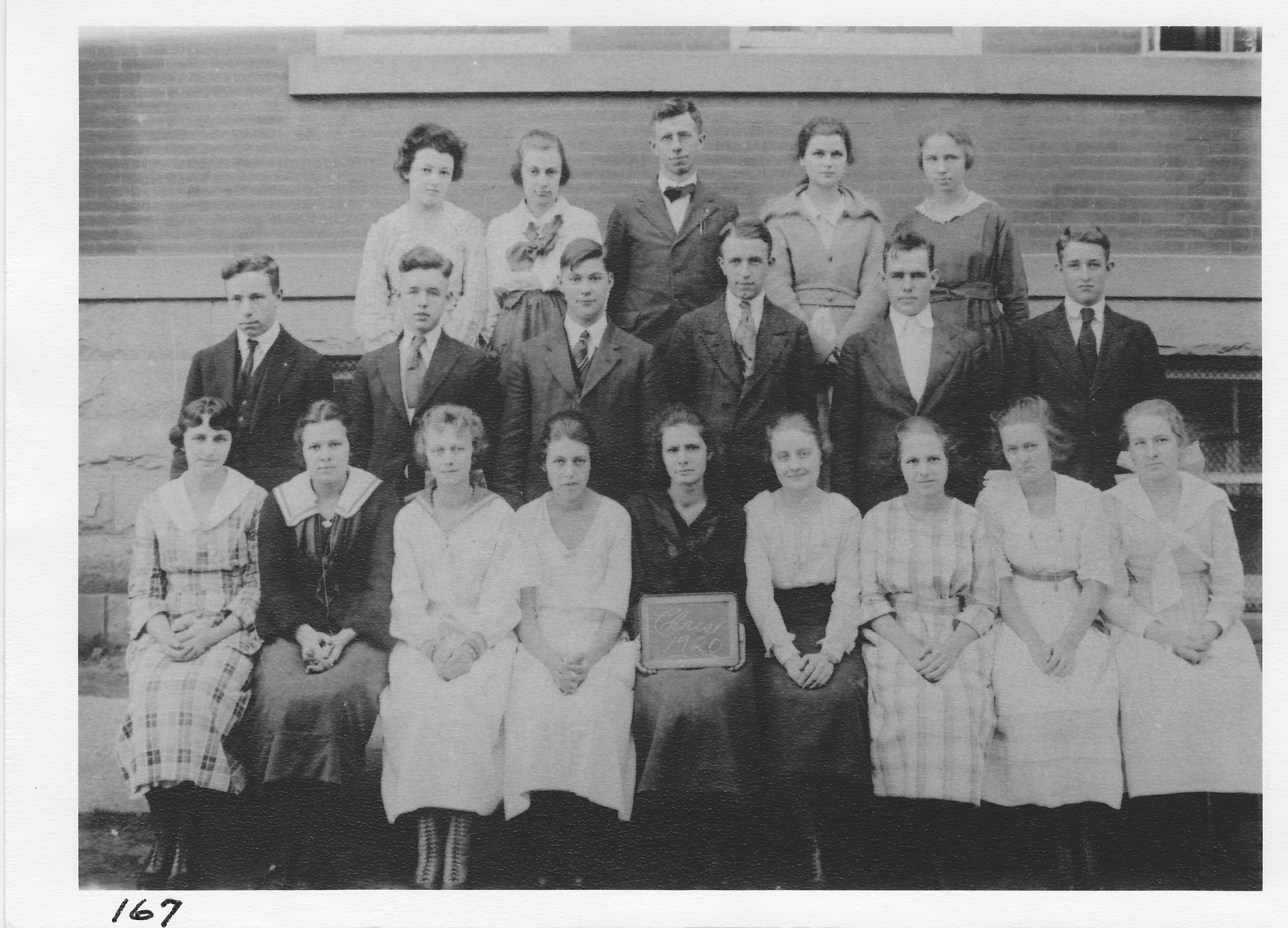 Class of 1920 Morenci High School.  Front row (l-r) Edith Amsler, Mildred Spencer, Mildred Cone, Daisy Keefer, Margaret Hoffman, Lottie Reynolds, Alyne Smith, Lila Gordon, Addie Sharr.  Second row (l-r) Floyd Lerch, Harold Brandon, Ben Colegrove, Jessie Green , Gayle May, Wayne Sutton.  Top row (l-r) Martha Fox, Lena Barber, Prof. Myers, Marie Thompson, Irene Goodyear (Porter).