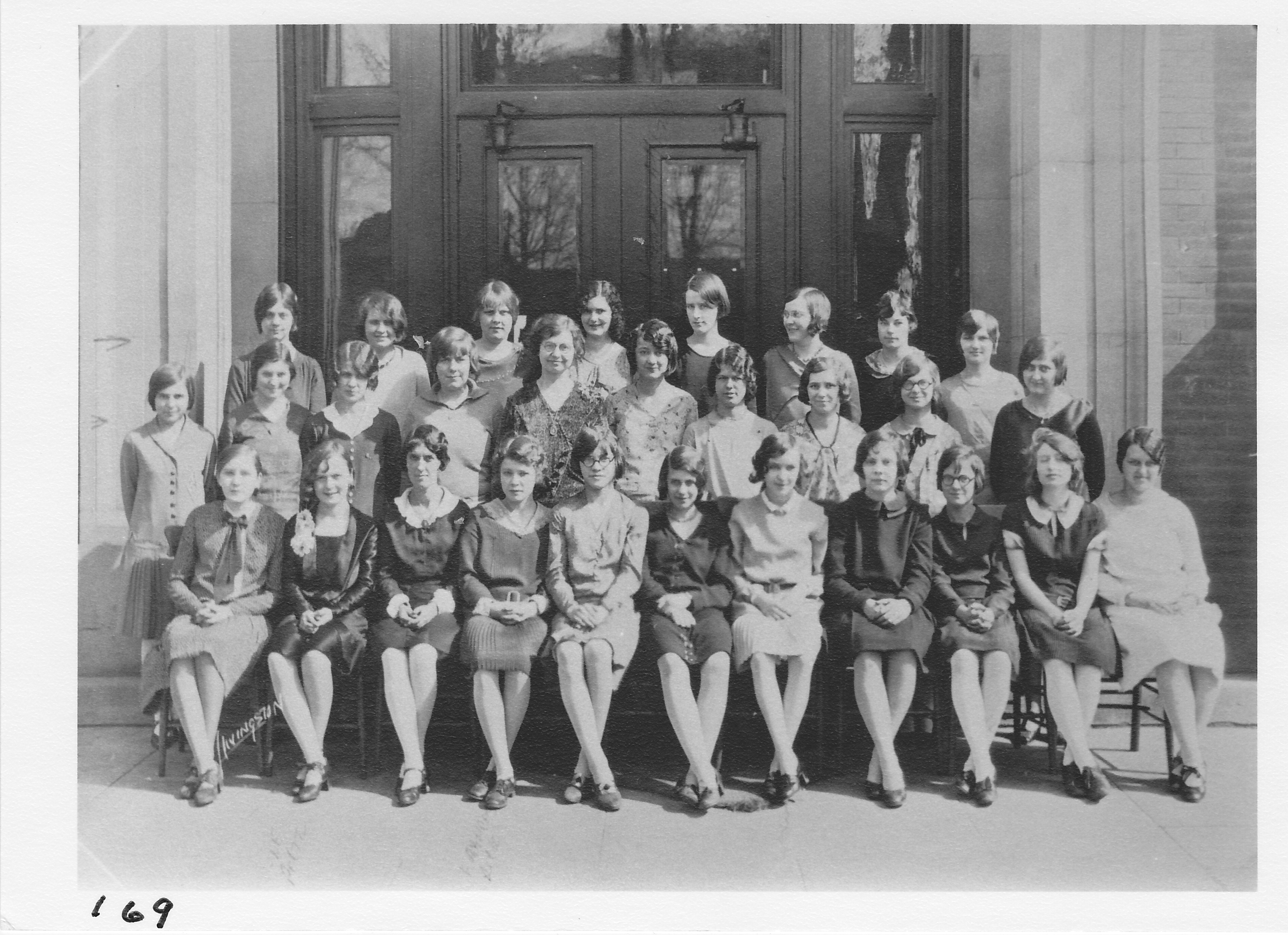 High School Chorus.  Top row (l-r) __________, ____________, Marjorie Wilsberg, ___________, _____ Ellis, ___________, Alice Guss, __________.  2nd row (l-r) Mabel King, __________, Virg Sims, Violte Poucher, A. Spooner (teacher), Alice M. Bishop, __________, __________, ___________, Eloise Smalley.  Front row (l-r) ____________, Irene Huffman, Ola Collins, Frances Rorick, Verna Meengs, ____________, Pauline Sonanstine, _____________, _____________, Irene Beadle, Sadora Thornburg, Opal Thompson.