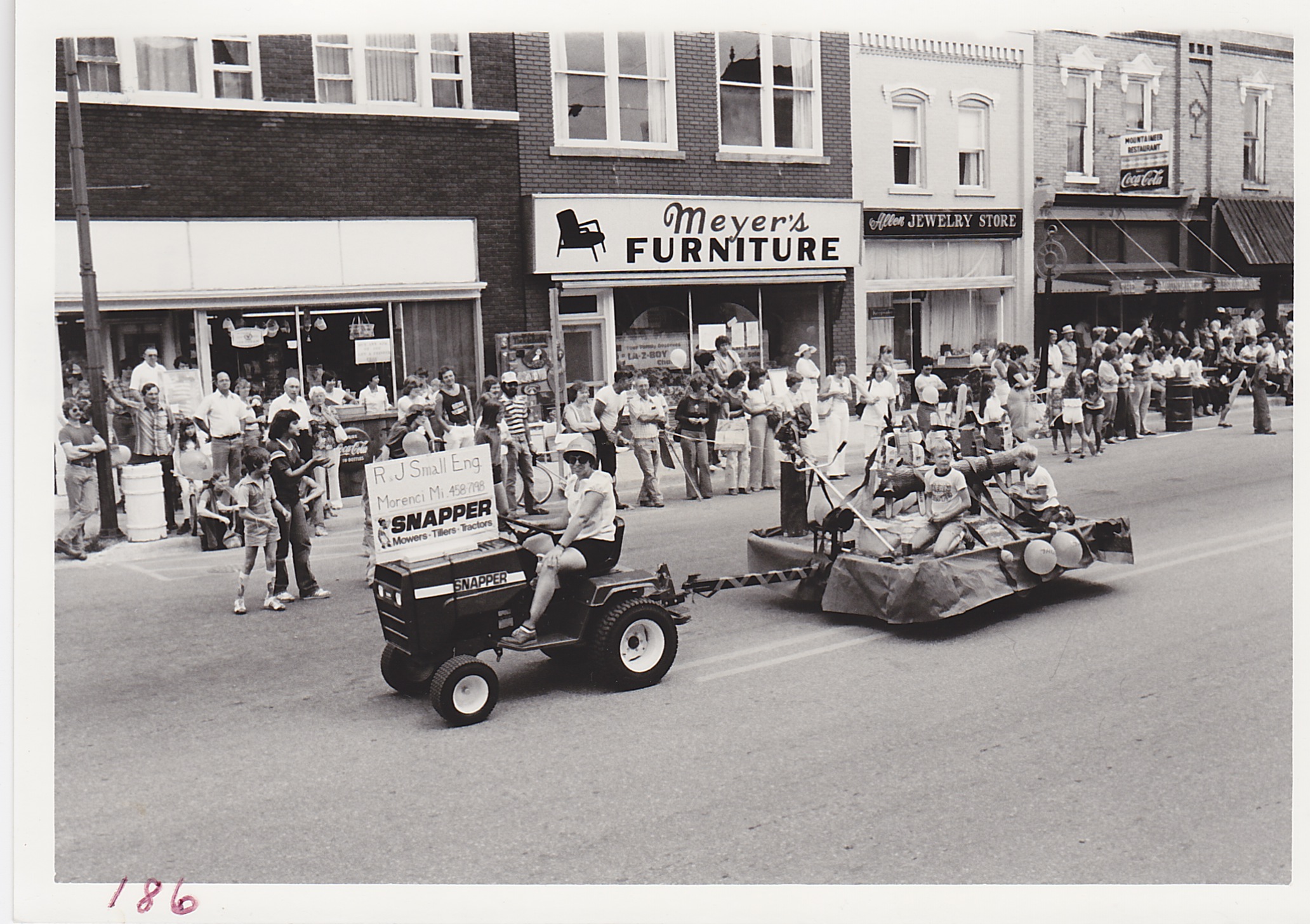 R & J Small Engine – Parade, Town and Country Festival, Aug. 15 and 16, 1980.  Jean Sholl on tractor, son Charles on wagon.