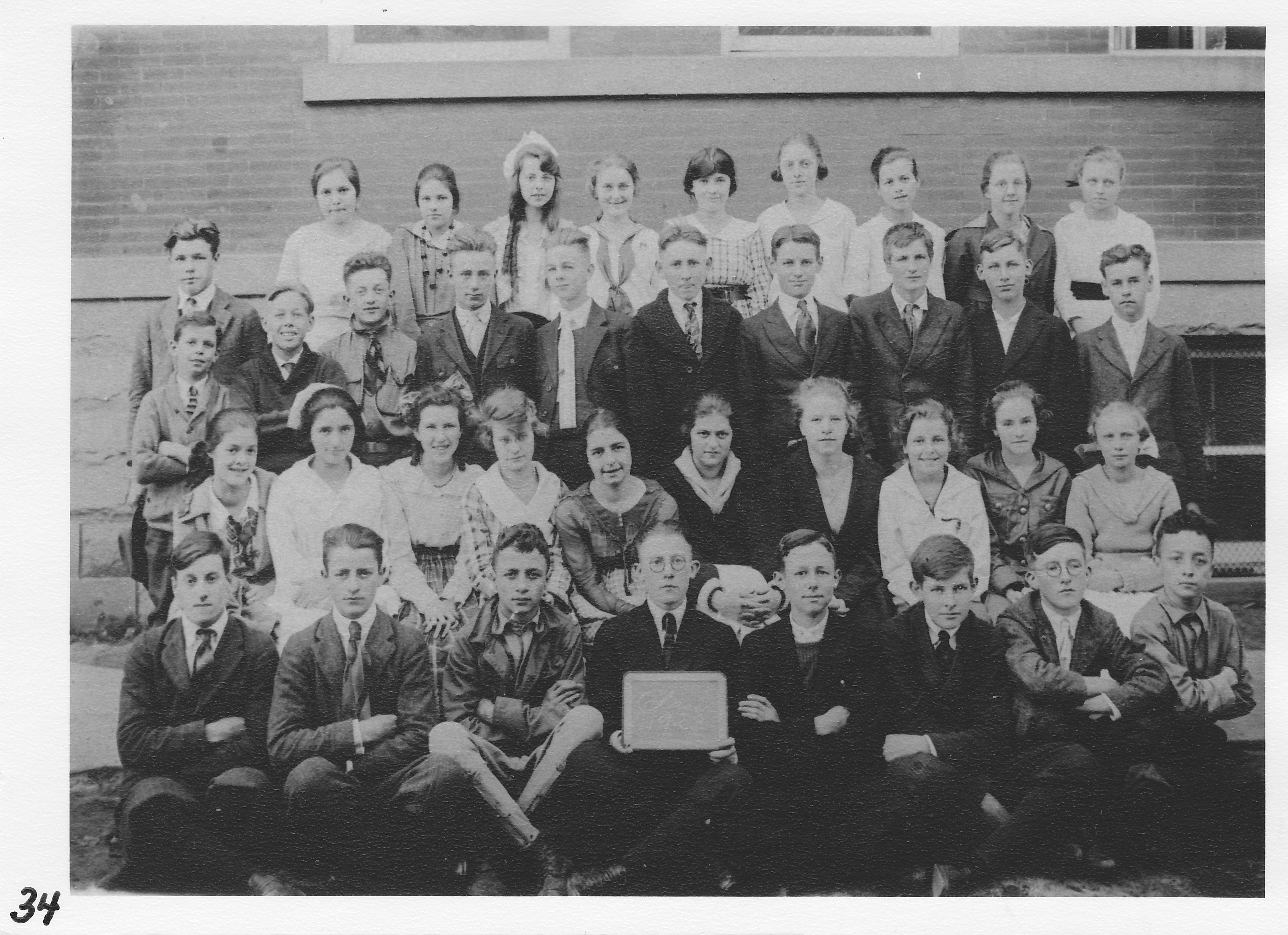 Morenci High School Class of 1923.  Photo taken Oct. 7, 1919 as “Freshman”.  1st left, top row,  Alberta Hoffman.      4th from left, 3rd row,  Ewart “Nim” Blair.    4th from right, 3rd row, Delbert Cottrell.    5th from left, 2nd row, Velma Ruth Clark.    2nd from right, 2nd row,  Leota Ashley.    1st from right, front row, Kenwood Morningstar. 3rd from  right, front row, Maxwell Smith.