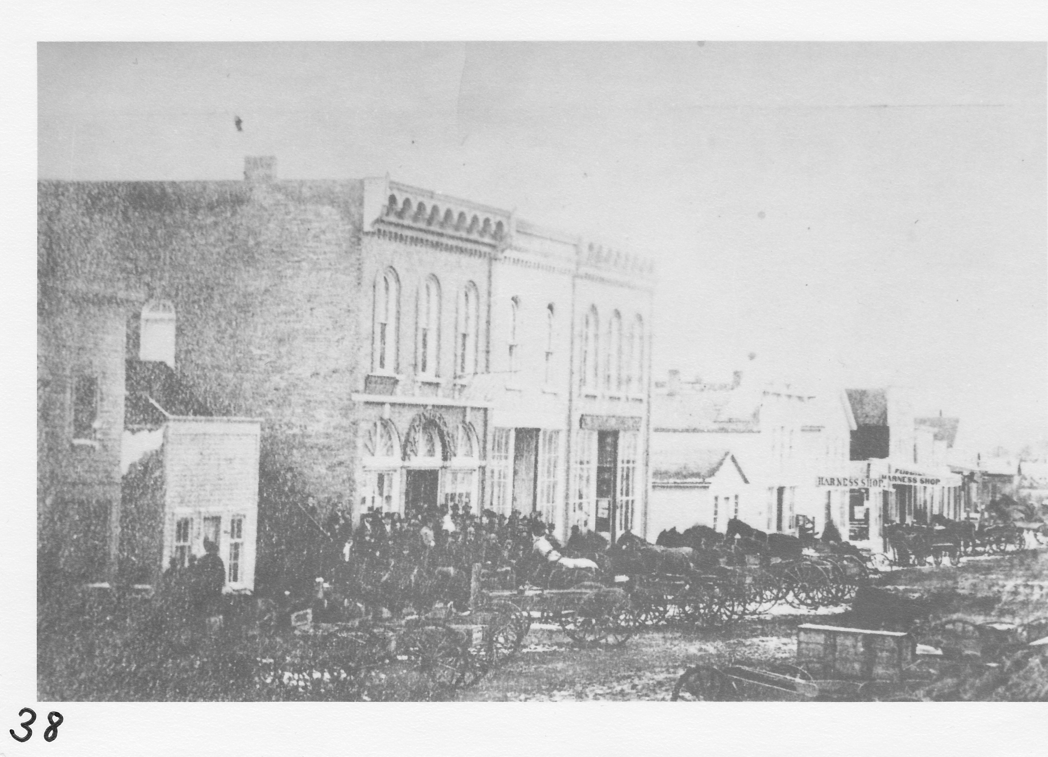 South side of  West  Main Street.  Oldest business district photo known to be in existence.   Civil War period in 1862-1865.  Buildings (l-r).   Shephard’s Bakery.   David Haight’s Drug Store (small bldg.-1853; still in use. George Smith Residence N. Summit).  J. P. Cawley Merchandise.   Hagamon & Garlick (Morenci Drug – built in 1862).   J. P. Richard’s Dry Goods (built in 1862- former Decker Hardware).