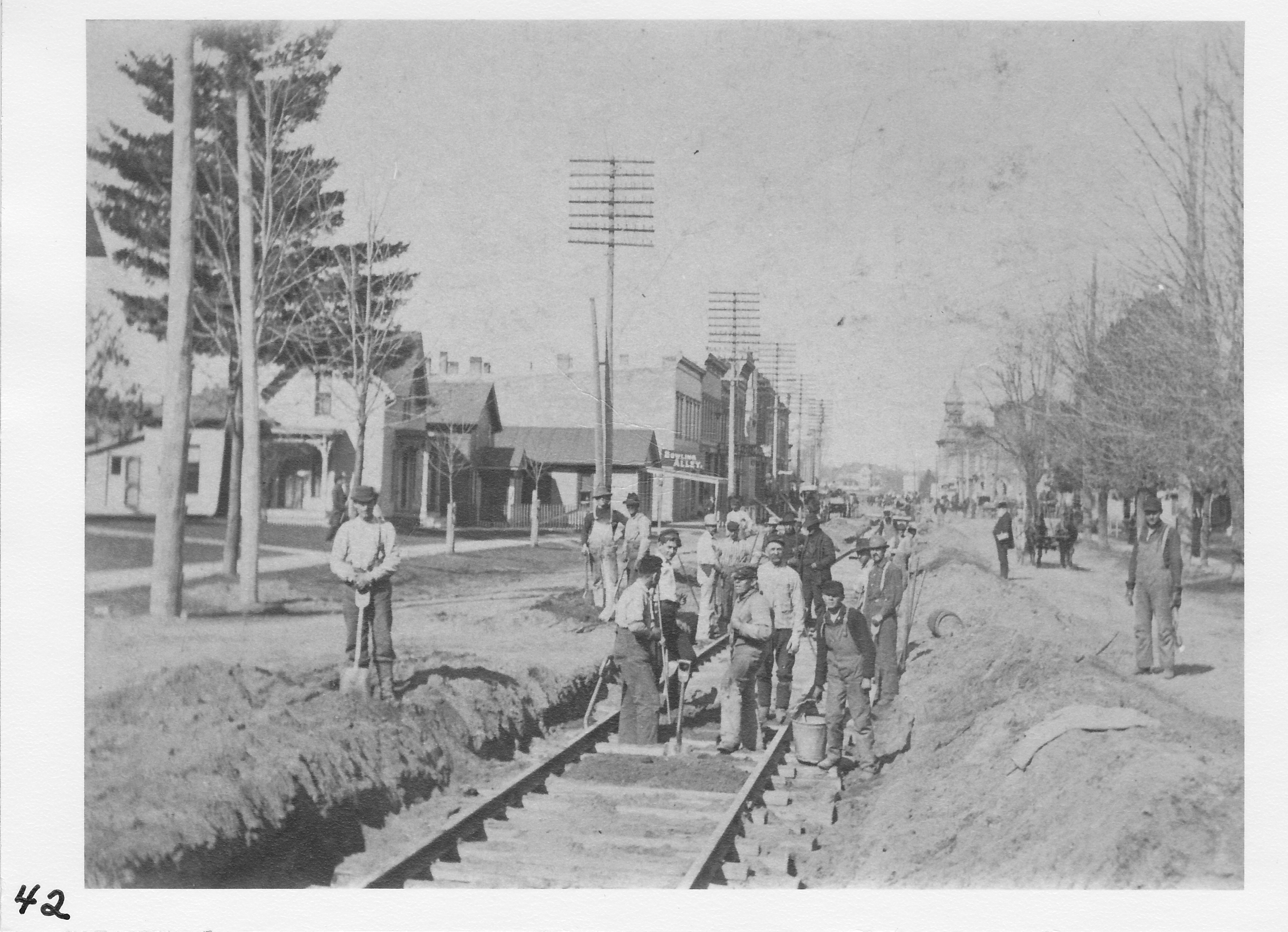 Laying track from Toledo & Western corner of Summit and West Main Street in 1902.   The team of white horses as seen owned by Clark Jones, father of Raynor Jones.