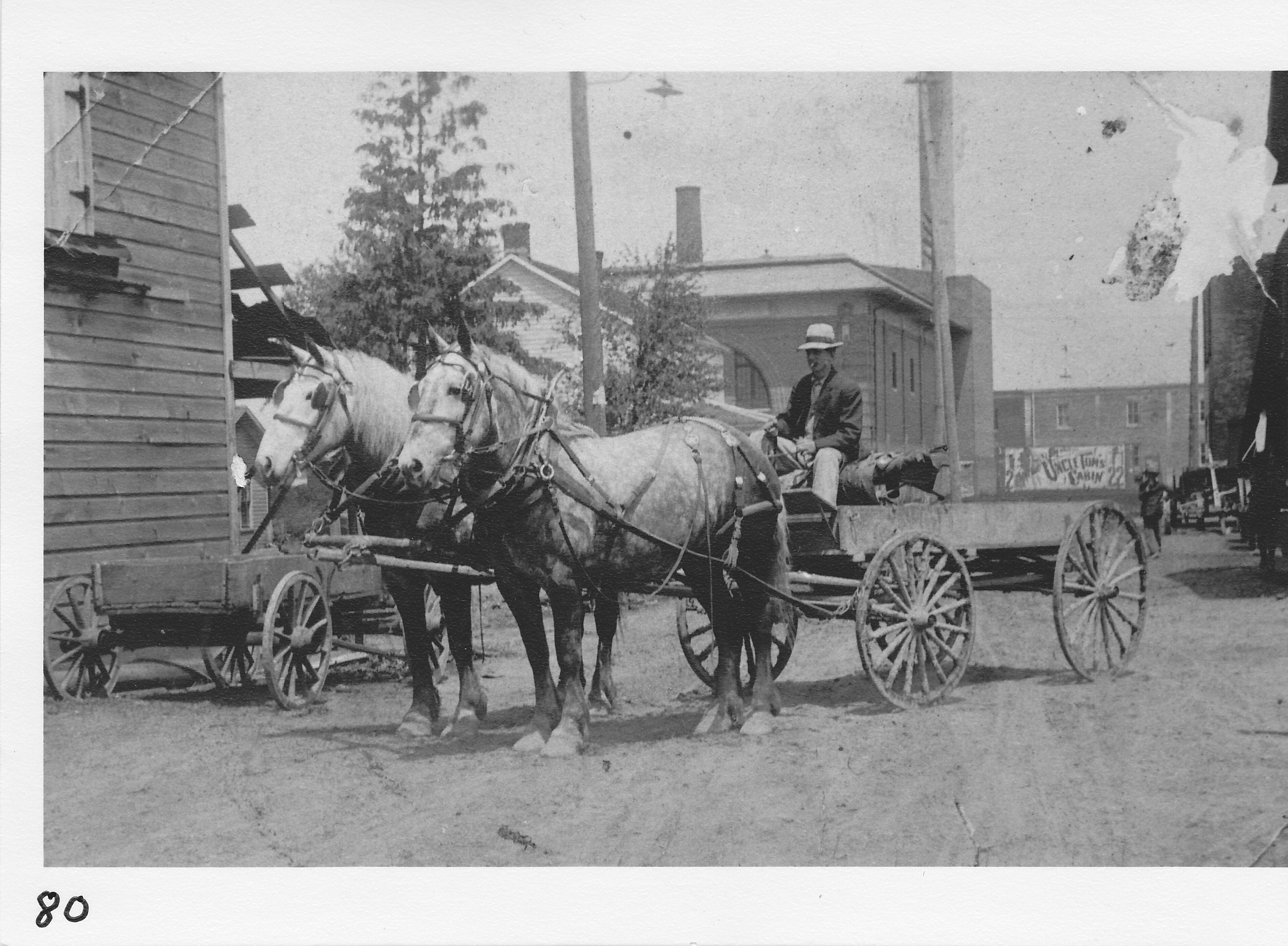 Neilingers Junk (also egg business), Baker Street.  Later owned by Charlie Fay.  Lester Terry in wagon.  Photo June 1909.  Note billboard advertising “Uncle Tom’s Cabin” in distance.