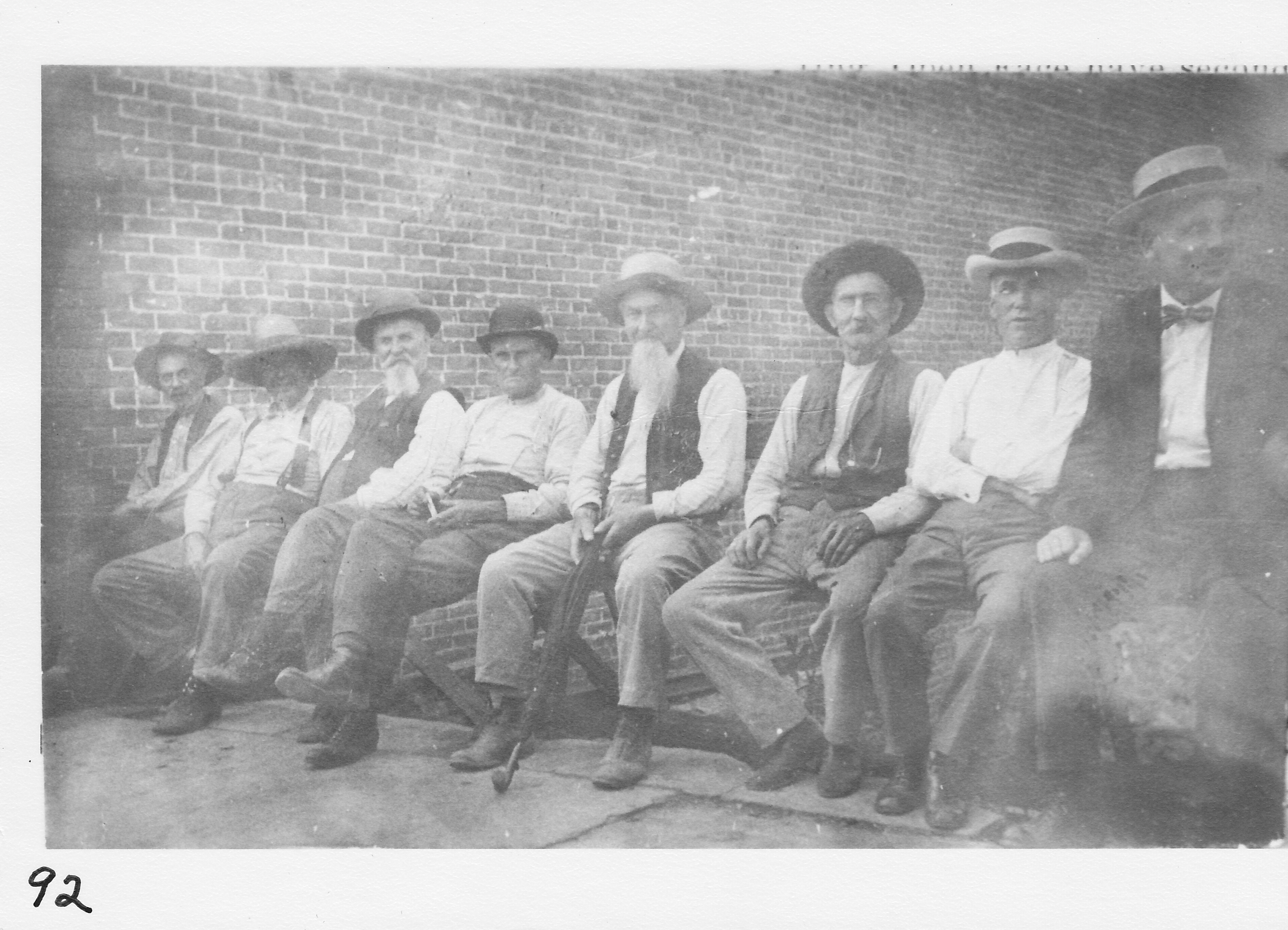 The “Village Senate.”  North side of West Main Street, east of Seebald Building. A gathering of some “cronies” on a warm spring day.  Site is an open area between corner store and Allen Jewelry. Fire in January 1912 destroyed previous building. Civil War veteran John Hanna (father of Olive Stephenson) – third from left. Civil War veteran William Onweller (father of Florence Anderson) – fourth from left.  Sam Humphrey, retired merchant, is shown second from left.  Photo taken between 1914 and 1915.