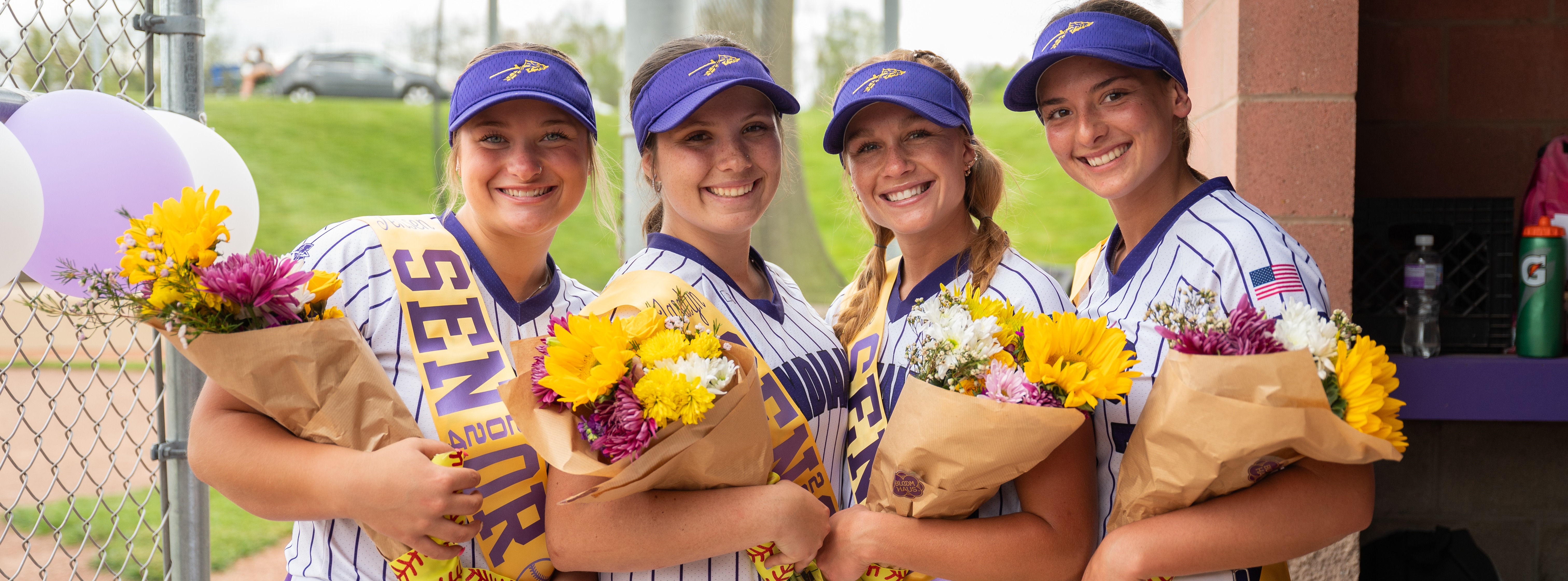 Girls Softball Senior Recognition Picture With Flowers