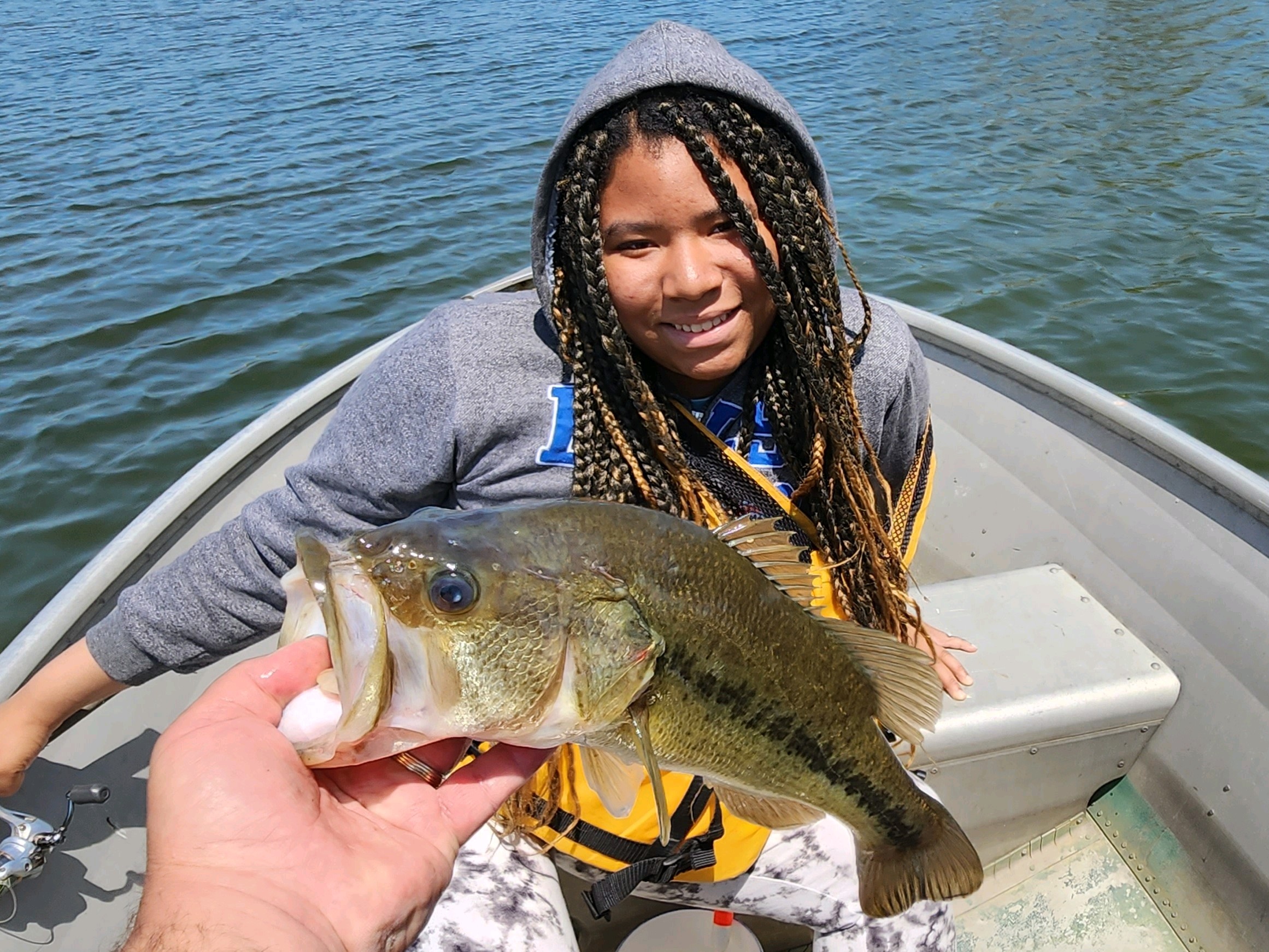 Student holds up fish they caught.