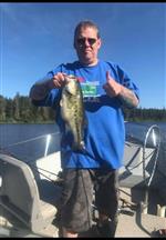 Staff member holding the fish he caught