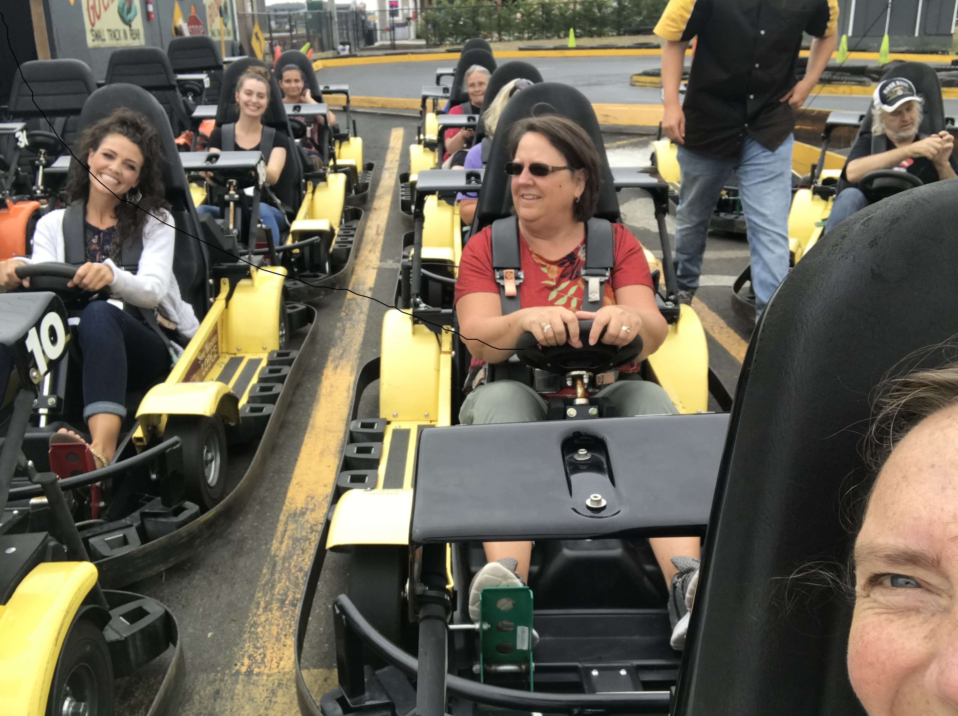 Staff member in go-carts on a staff bonding day