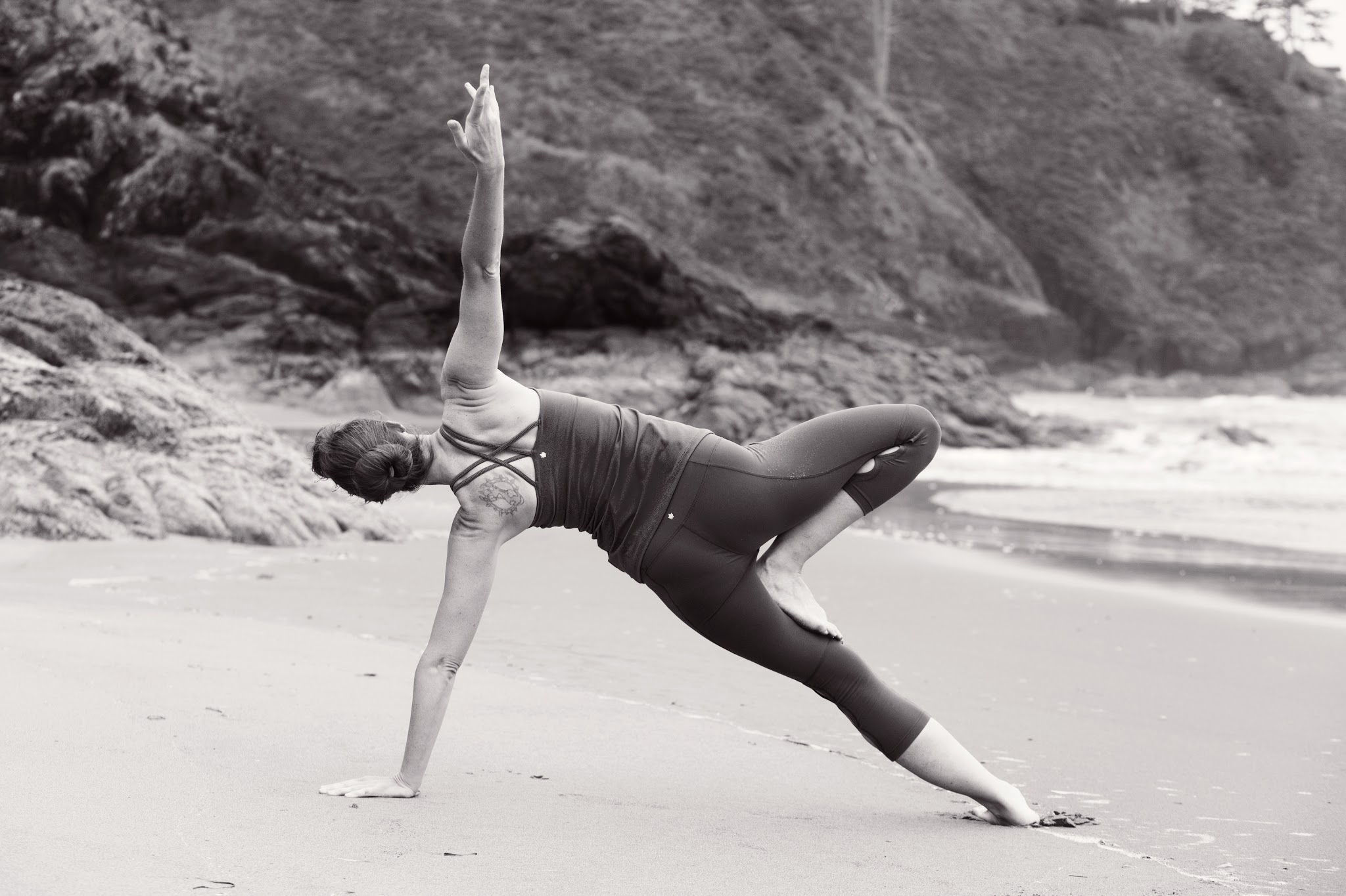 Principal doing yoga on the beach