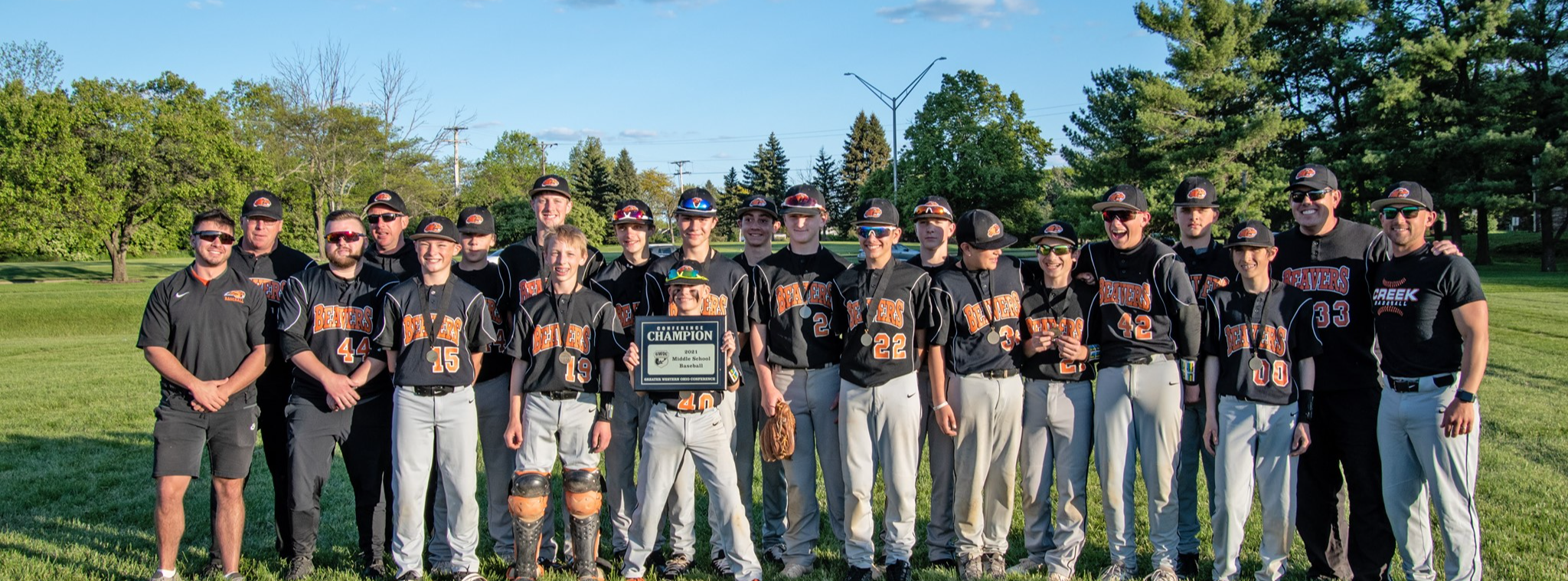 Baseball team hold conference championship plaque