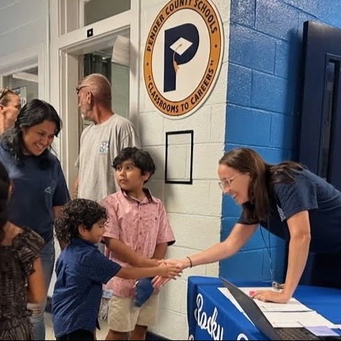Mrs. Perkins greets students at the front door