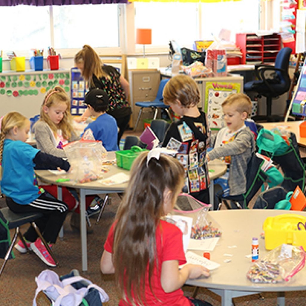 Kindergarten students actively engaged in  an activity in a kindergarten classroom