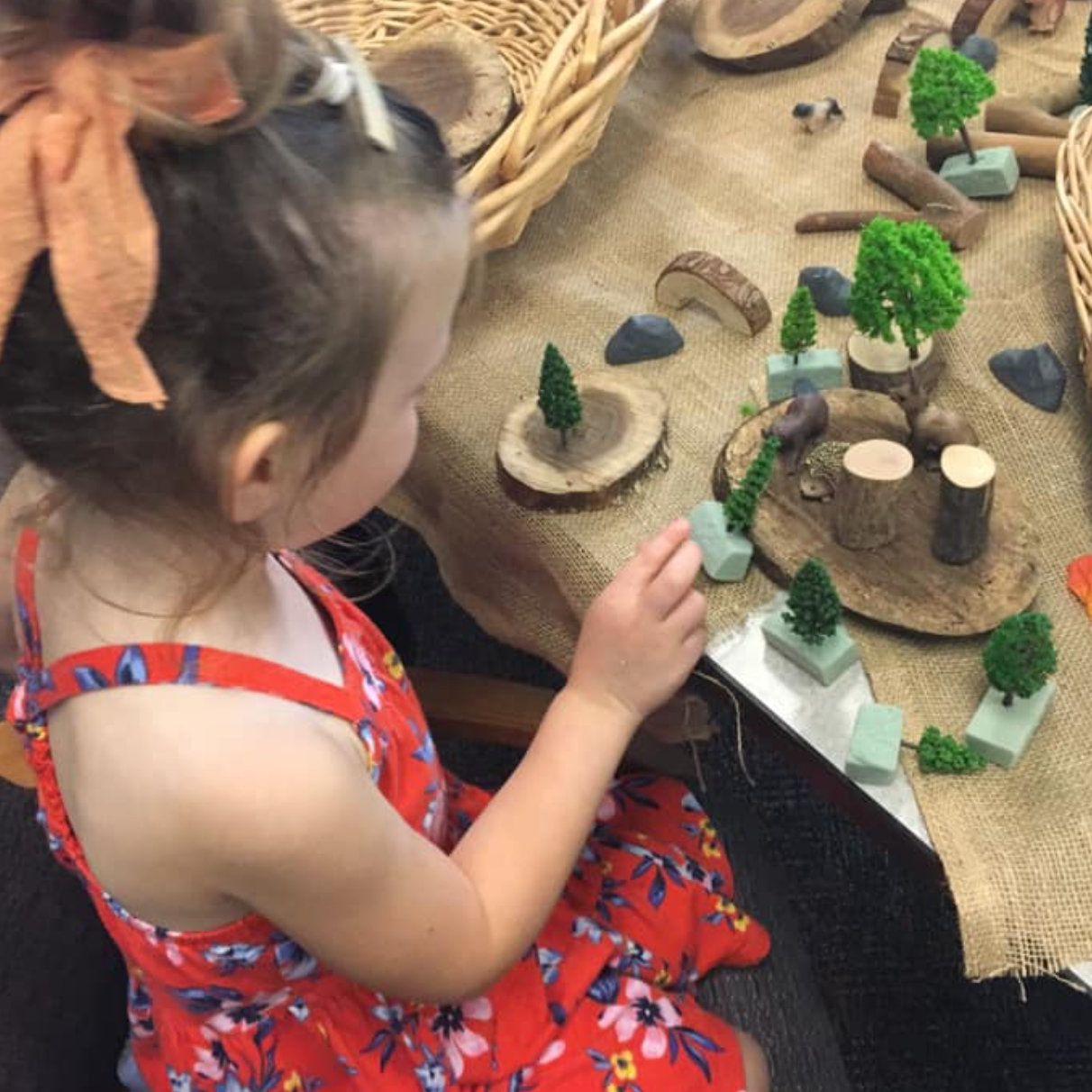 child using nature items to build a small world