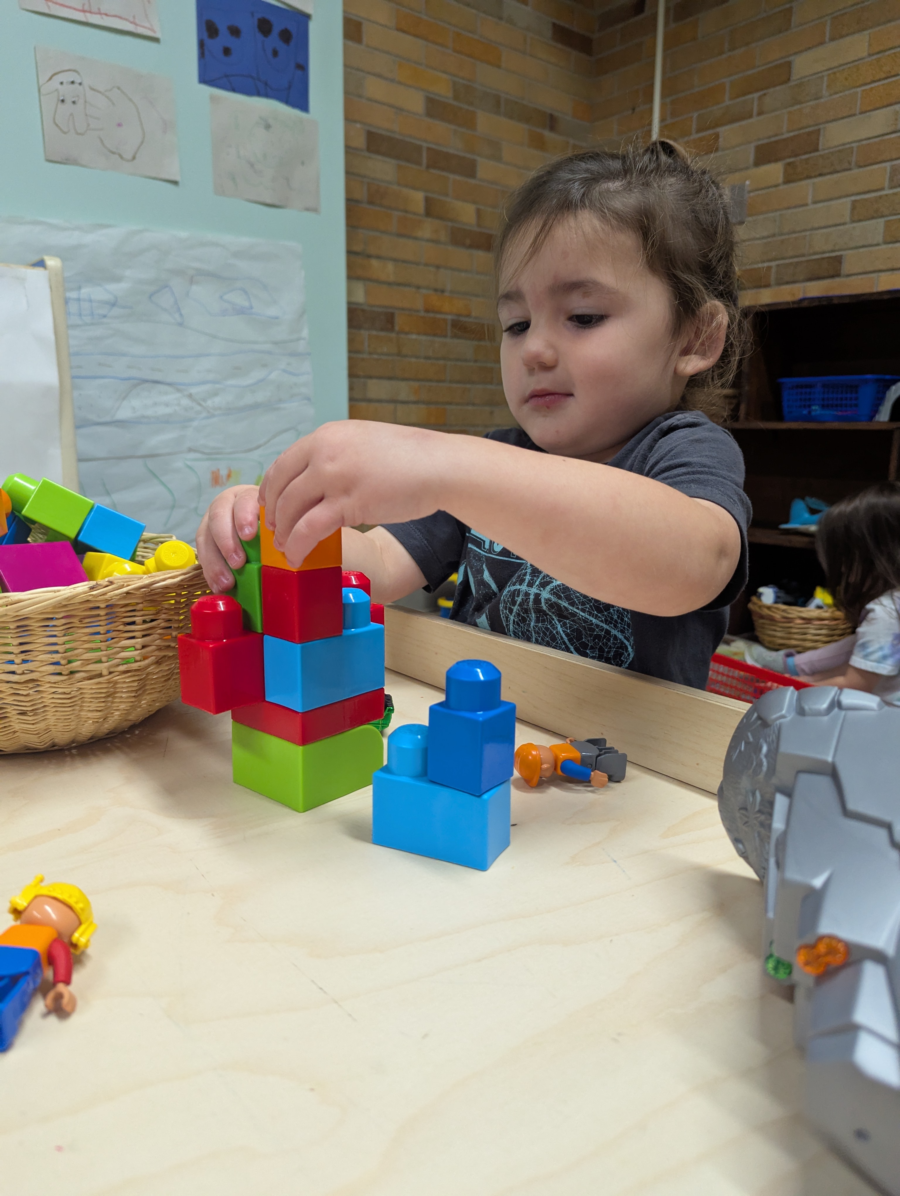 boy building with legos at table