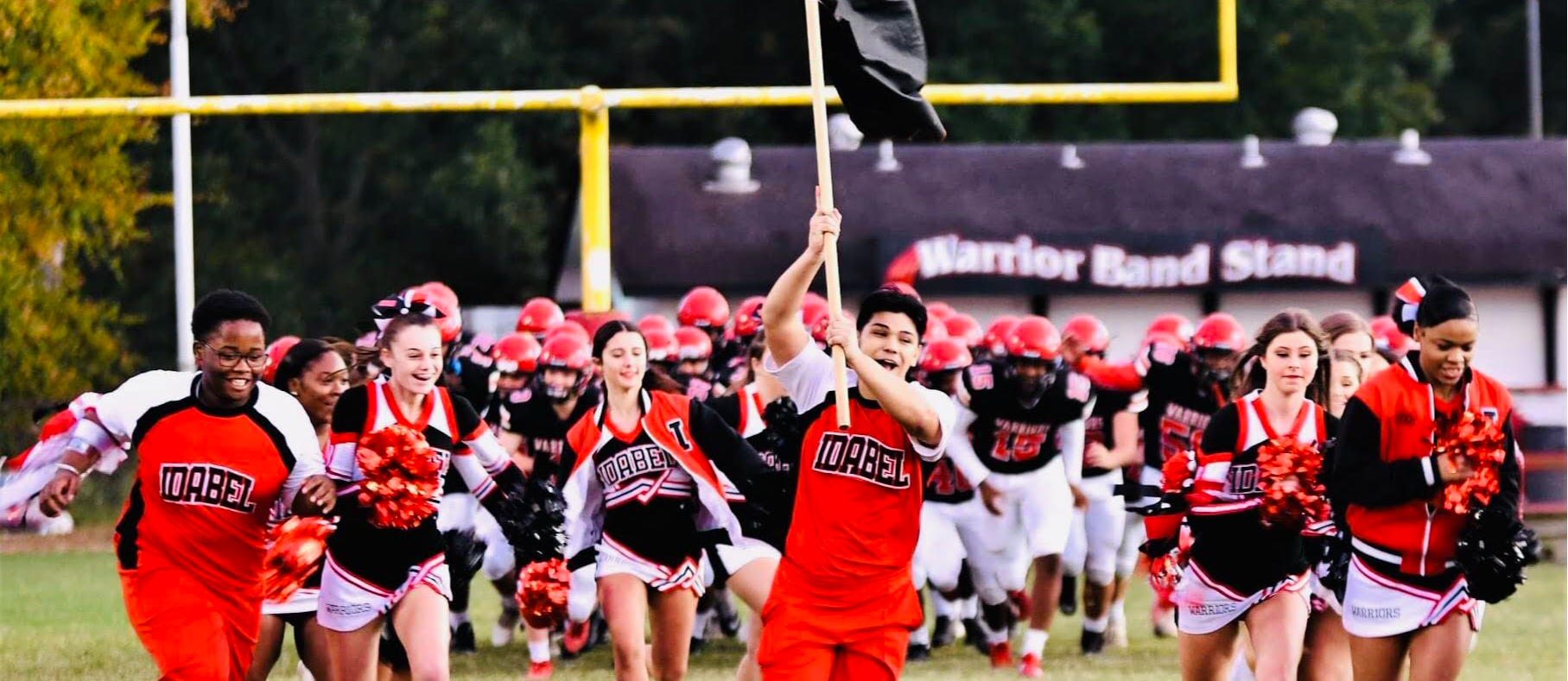 Student running with flag before football game