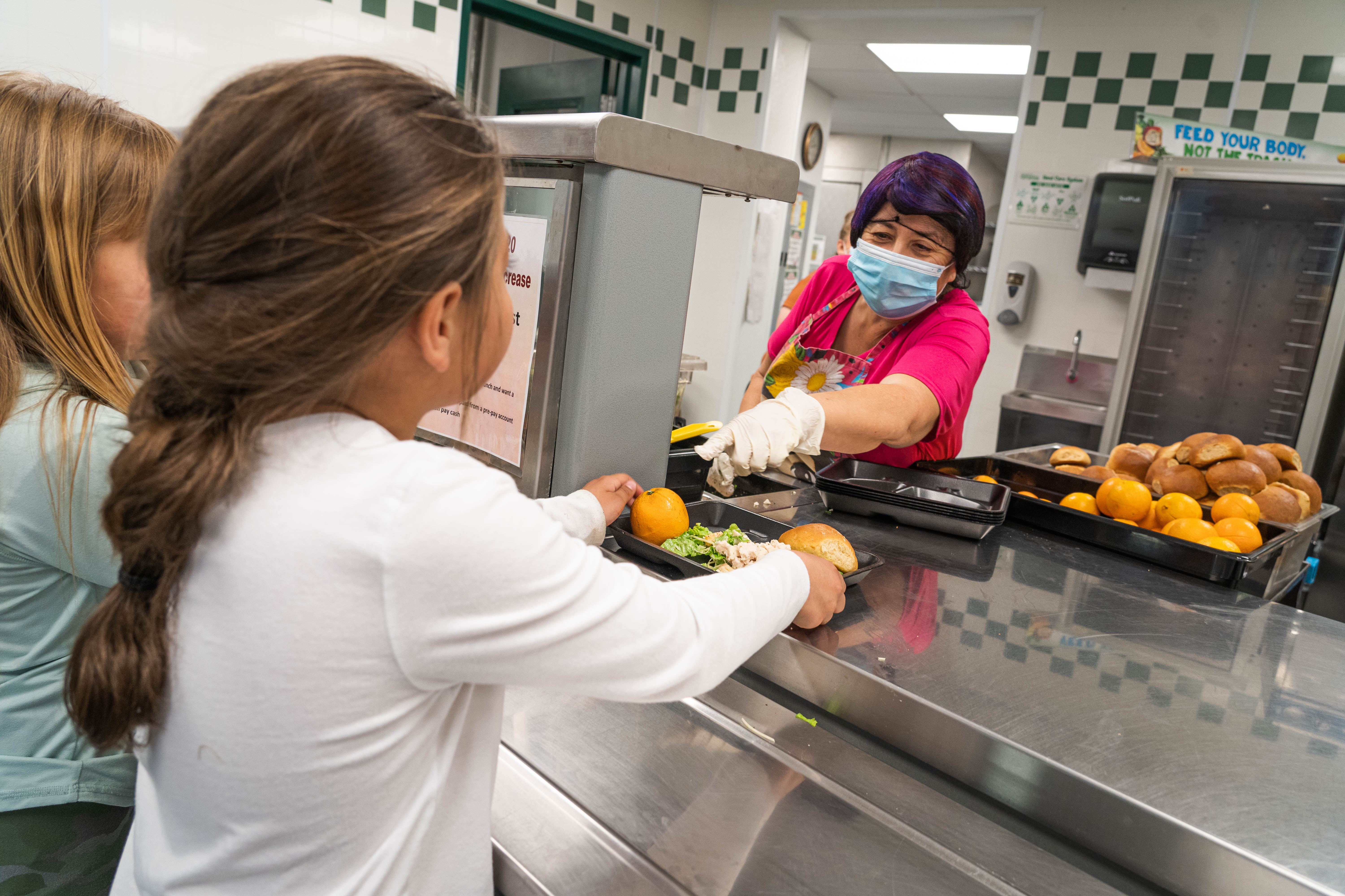 Student Nutrition worker serving lunch to a student