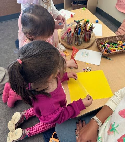 Two children writing together