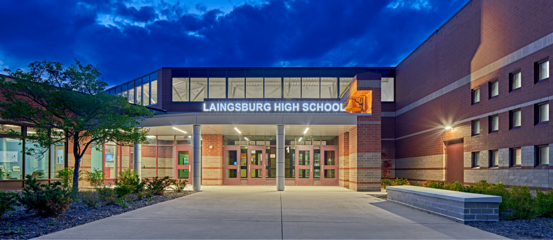 Welcome to laingsburg high school written over picture of a road surrounded by trees 