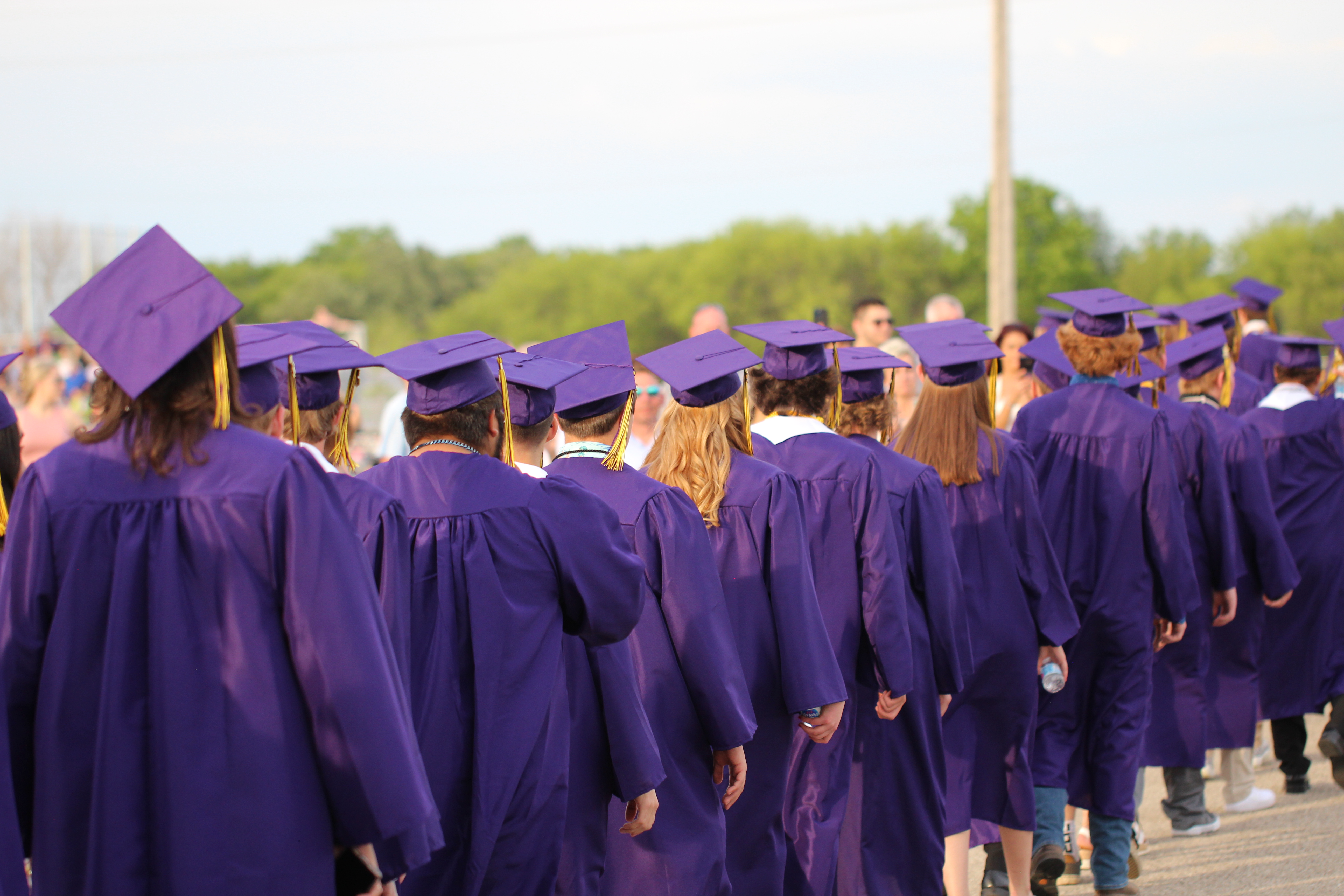 High school students in purple graduation caps and gowns