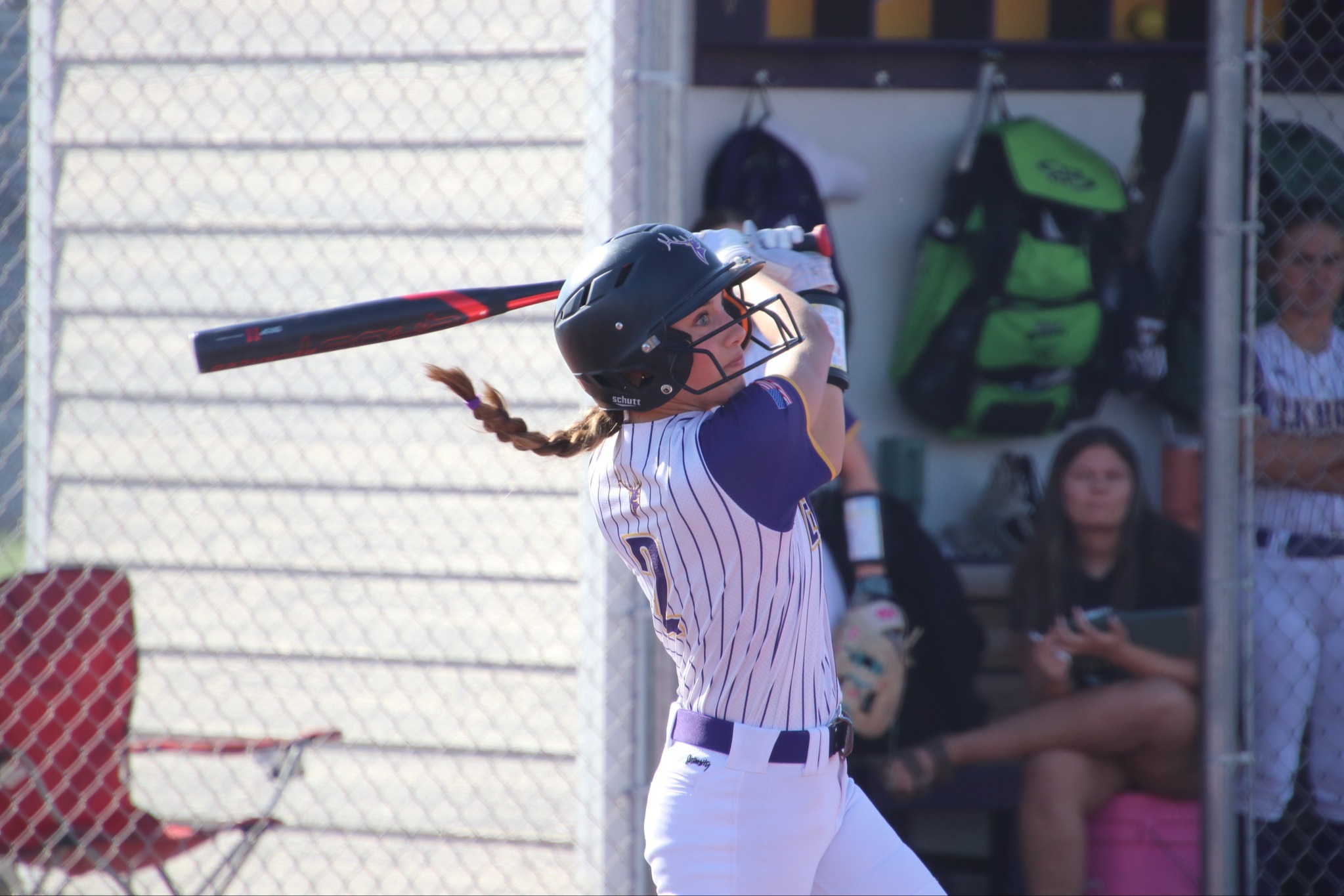 Elkhorn softball player swinging bat