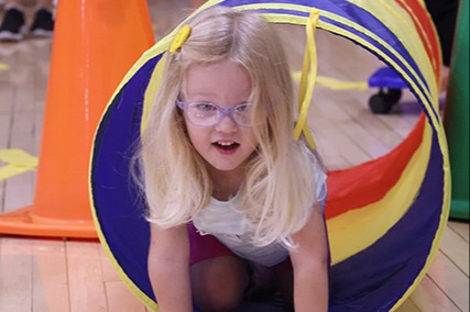 Young girl in rainbow tunnel
